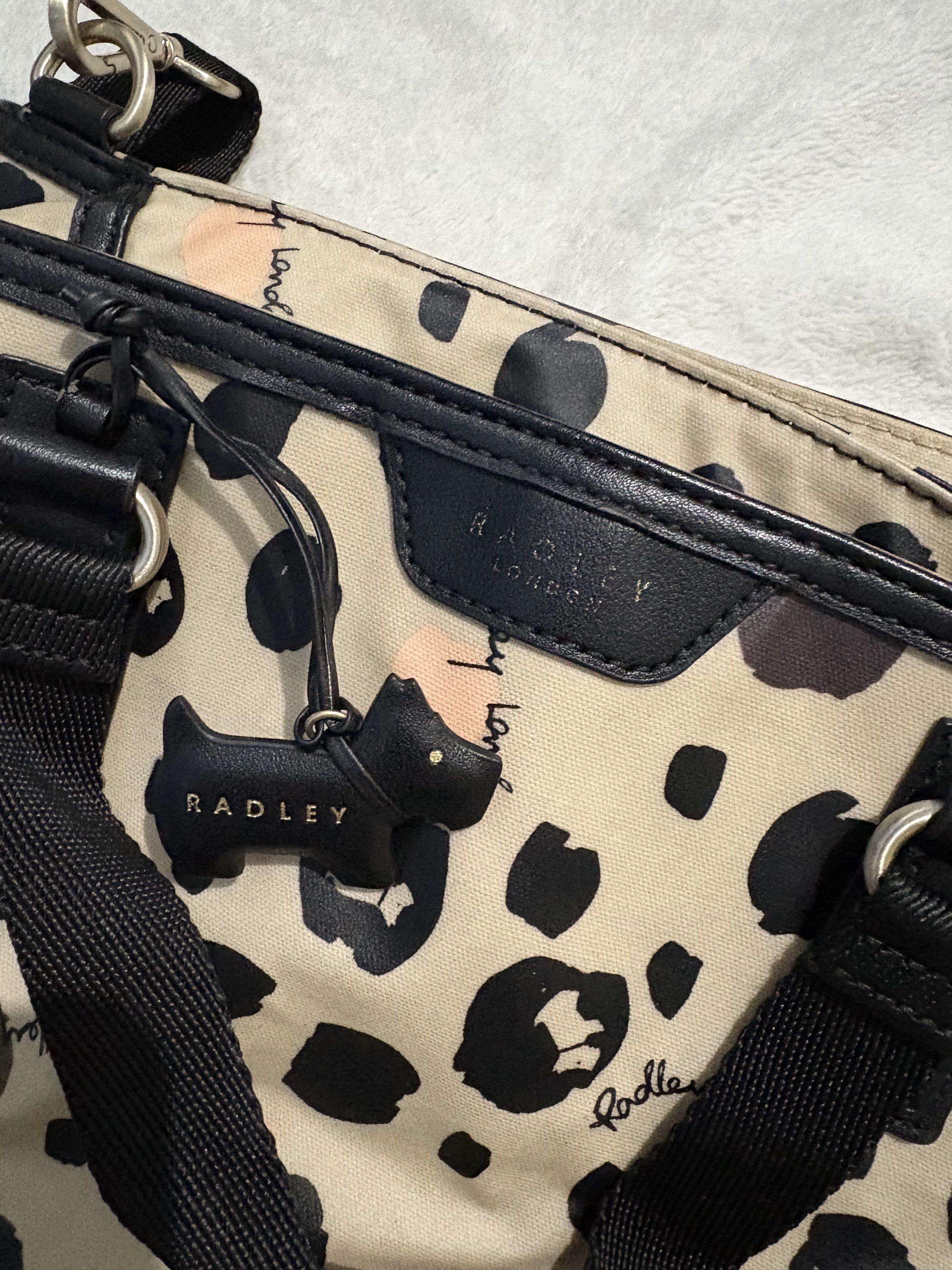 Radley London Leopard Print Handbag (Category: Luxury Bags & Wallets) located in Quezon City. Submitted by tonipatootie (Listing ID 1417296598, Image 3). Description: DECLUTTERING - Radley London handbag with a stylish leopard print. - Features a top handle and a detachable shoulder strap. - Offers versatile carrying options. - Interior includes multiple compartments. - Secure zip closure. - Comes with the iconic Radley dog charm. - Light pink in