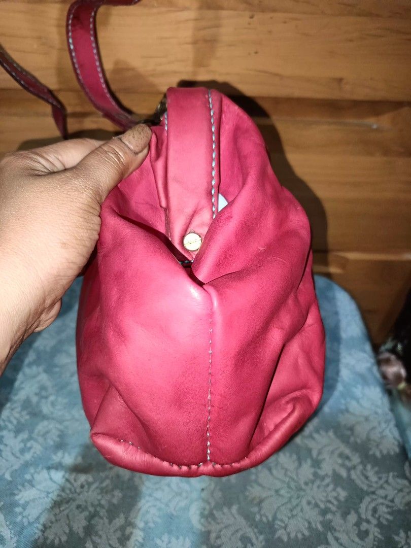 Red Leather Doctor Bag (Category: Cross-body Bags) located in Baguio. Submitted by iyaberong48242 (Listing ID 1417336479, Image 3). Description: - Red leather doctor bag - Top handle and detachable shoulder strap - Clasp closure - Visible stitching details - Matching fabric interior lining.