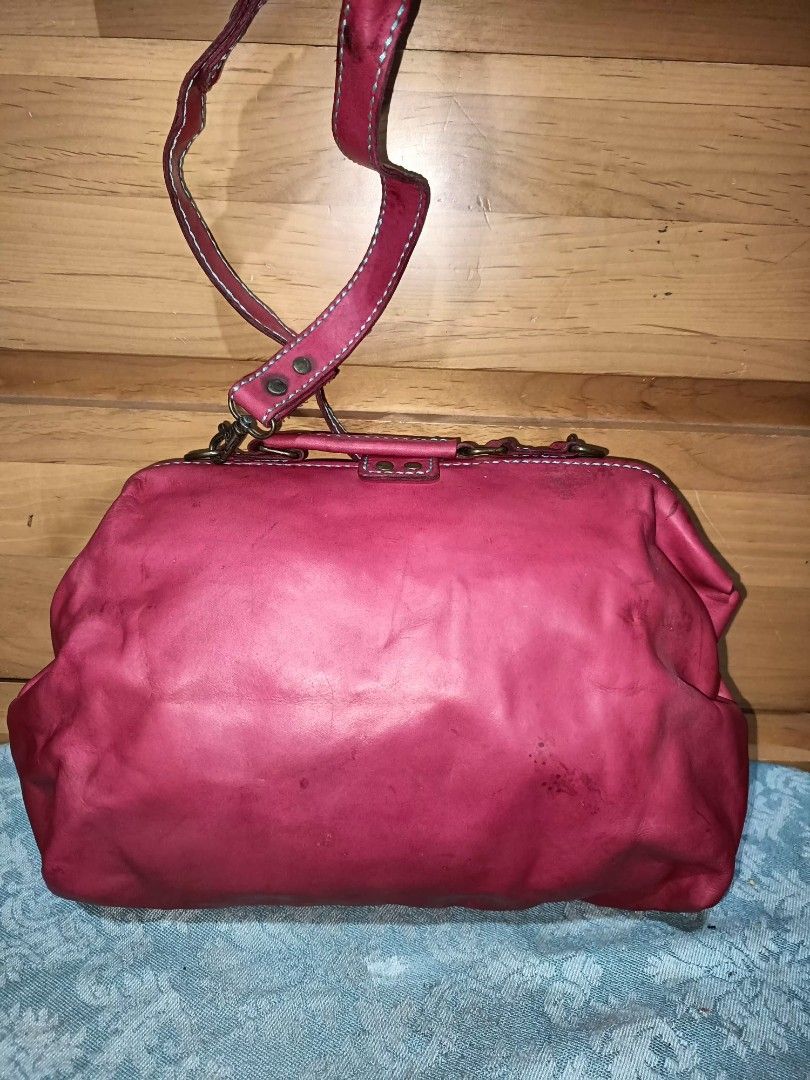 Red Leather Doctor Bag (Category: Cross-body Bags) located in Baguio. Submitted by iyaberong48242 (Listing ID 1417336479, Image 2). Description: - Red leather doctor bag - Top handle and detachable shoulder strap - Clasp closure - Visible stitching details - Matching fabric interior lining.