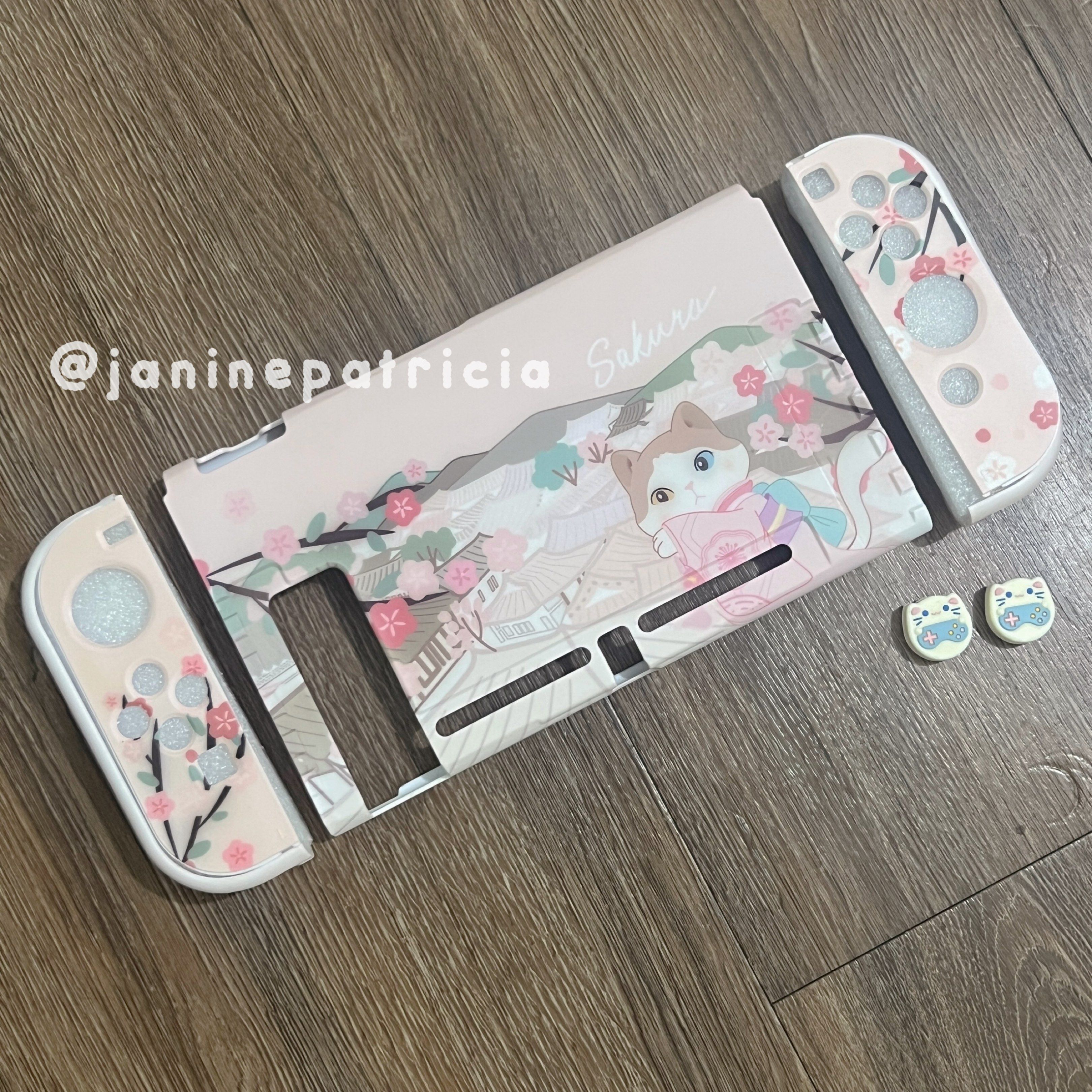 Sakura Cat Nintendo Switch Case (Category: Cases & Covers) located in Pasay City. Submitted by janinepatricia (Listing ID 1417368431, Image 1). Description: Preloved Nintendo Switch V1/V2 Case. Still in good condition. Bought from Paw Diary. Free preloved cat thumb grips. Not compatible with Nintendo Switch 2/OLED/Lite..