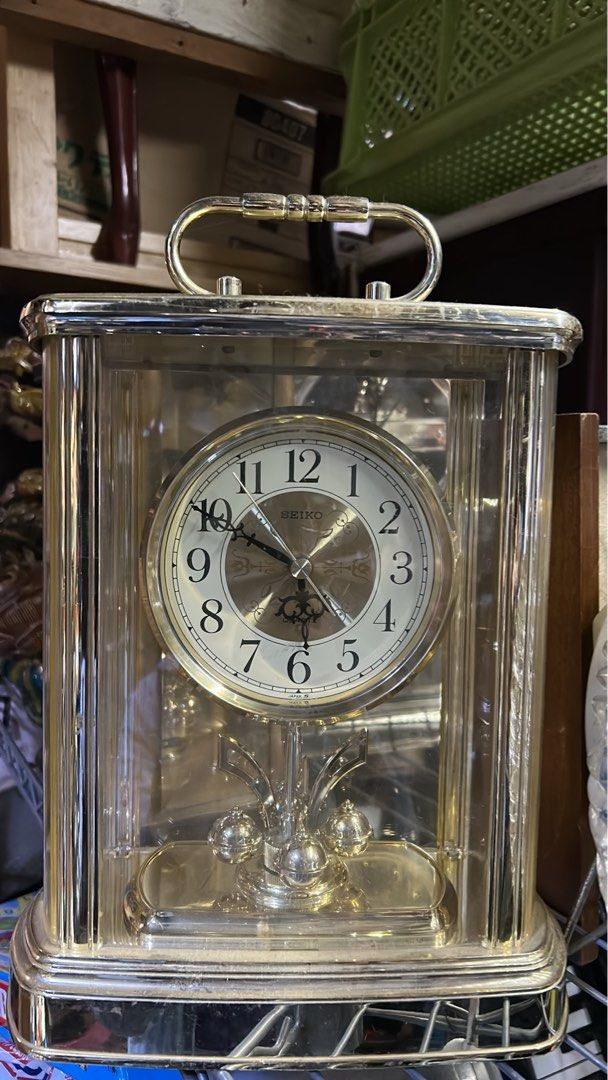 STUNNING GOLD DECOR TABLE CLOCK WITH PIVOTING ORNAMENT (Category: Clocks) located in Valenzuela. Submitted by gregferraren (Listing ID 1417331079, Image 1). Description: Imported Seiko Uses 2 AA batteries Made of Bento material. note: dusty from shipping. Sure buyer may inquire video/ charged real time delivery or shipping nationwide upon confirming order thru preferred metrobank/ bdo/ gotyme bank/ maya bank payment channels..