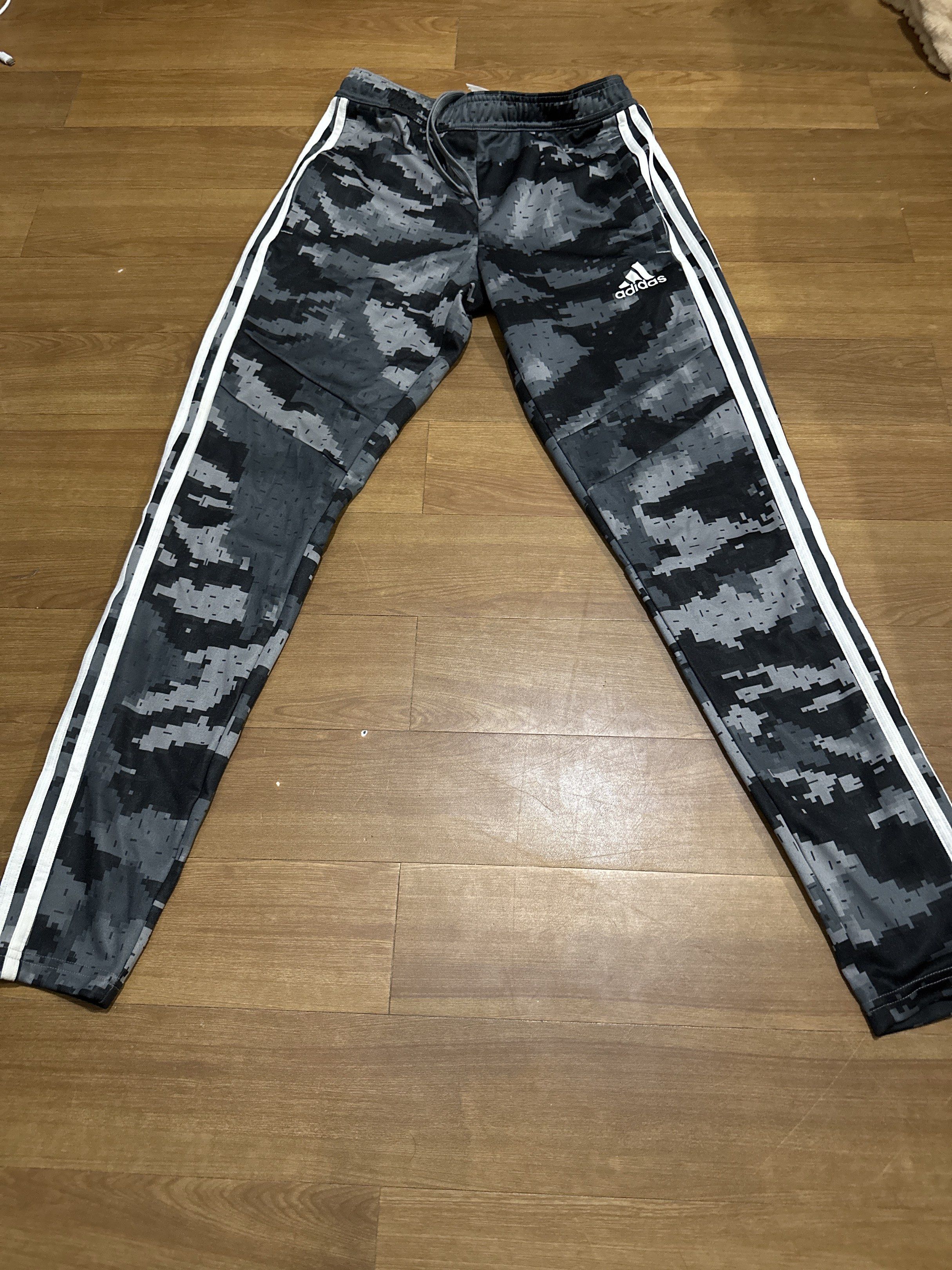 Adidas Camo Track Pants XS (Category: Joggers) located in Pasig City. Submitted by jhadsan (Listing ID 1417474492, Image 1). Description: - Adidas track pants - Digital camo pattern - Adidas logo detail - Iconic three white stripes - Drawstring waist - Size: XS - Made in Vietnam.