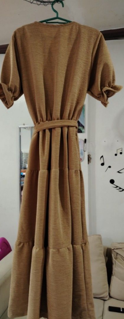Brown Wrap Dress with Belt (Category: Dresses) located in Rizal. Submitted by zhellieme (Listing ID 1417440149, Image 2). Description: -Used only once - Brown wrap dress - V-neck design - Short sleeves with ruffled cuffs - Tiered skirt - Matching belt included - Textured fabric - Flowing silhouette - Suitable for various occasions.