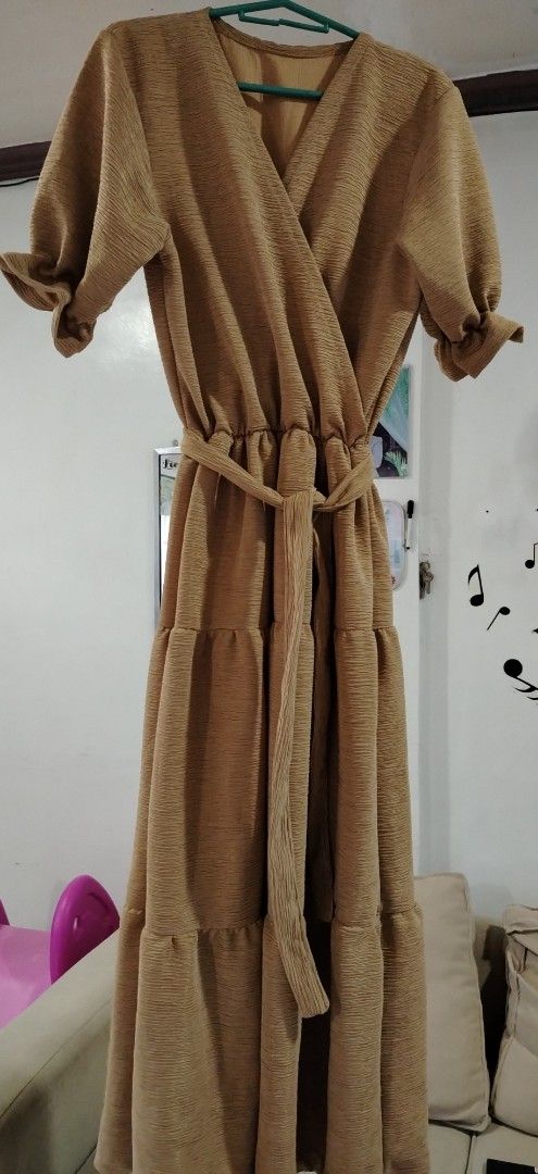 Brown Wrap Dress with Belt (Category: Dresses) located in Rizal. Submitted by zhellieme (Listing ID 1417440149, Image 1). Description: -Used only once - Brown wrap dress - V-neck design - Short sleeves with ruffled cuffs - Tiered skirt - Matching belt included - Textured fabric - Flowing silhouette - Suitable for various occasions.