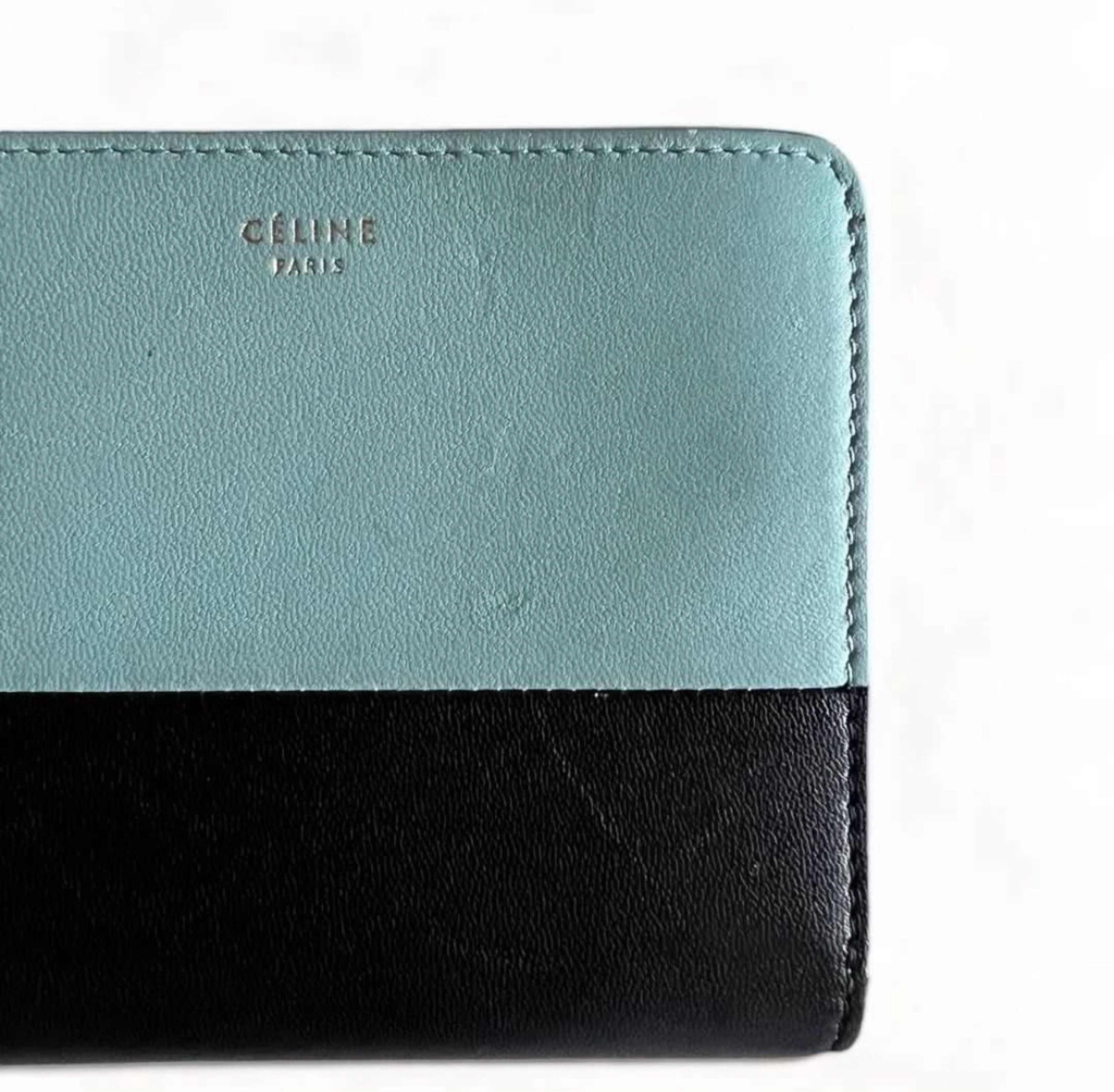 CELINE Bi-Color Leather Wallet (Category: Luxury Bags & Wallets) located in Davao. Submitted by allthisandmore (Listing ID 1417417225, Image 3). Description: Details: Bi-color black design | Smooth leather interior | matte finish with a fine grain | zip-around closure with slim leather zipper pull | compact square | central compartment for bills (folded) | card slots along the sides | zip compartment for coins Inclusion: Dust Bag Well Used (Light