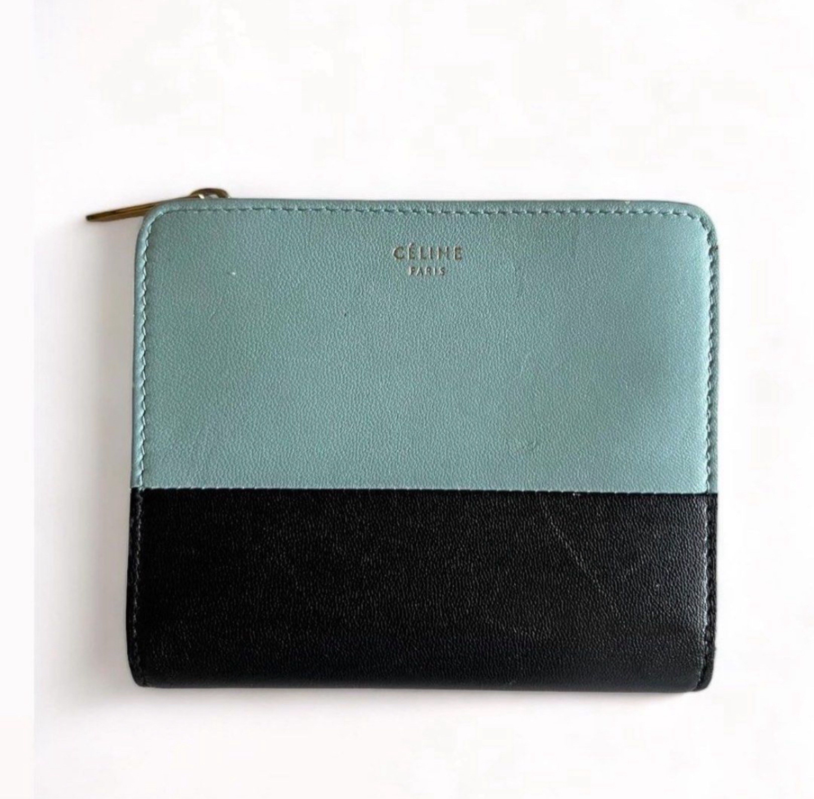 CELINE Bi-Color Leather Wallet (Category: Luxury Bags & Wallets) located in Davao. Submitted by allthisandmore (Listing ID 1417417225, Image 1). Description: Details: Bi-color black design | Smooth leather interior | matte finish with a fine grain | zip-around closure with slim leather zipper pull | compact square | central compartment for bills (folded) | card slots along the sides | zip compartment for coins Inclusion: Dust Bag Well Used (Light