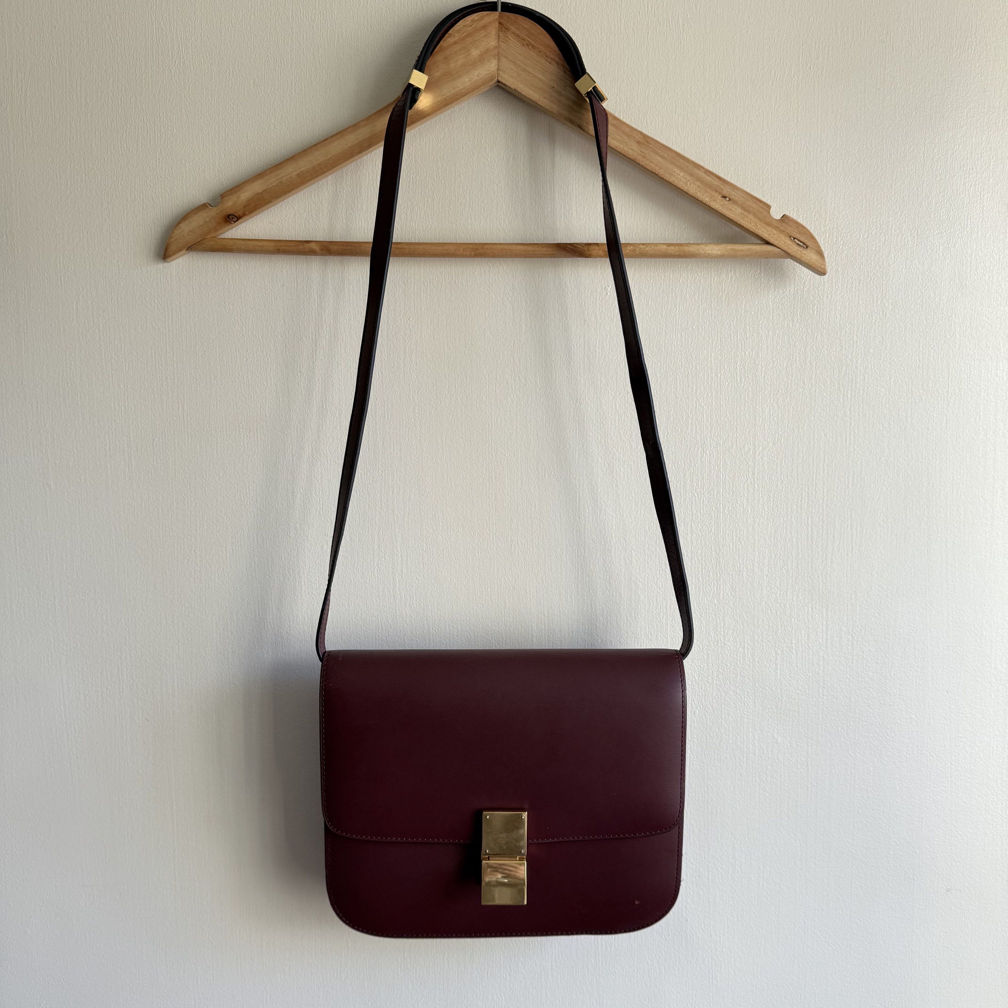 Celine Box Bag Burgundy (Category: Luxury Bags & Wallets) located in Quezon City. Submitted by toomuchpain (Listing ID 1417481043, Image 1). Description: - Authentic Celine Box Bag in Burgundy - Gold-tone clasp - Interior with multiple compartments and a zippered pocket - Marked "CELINE PARIS" inside - Made in Italy - Includes shoulder strap.
