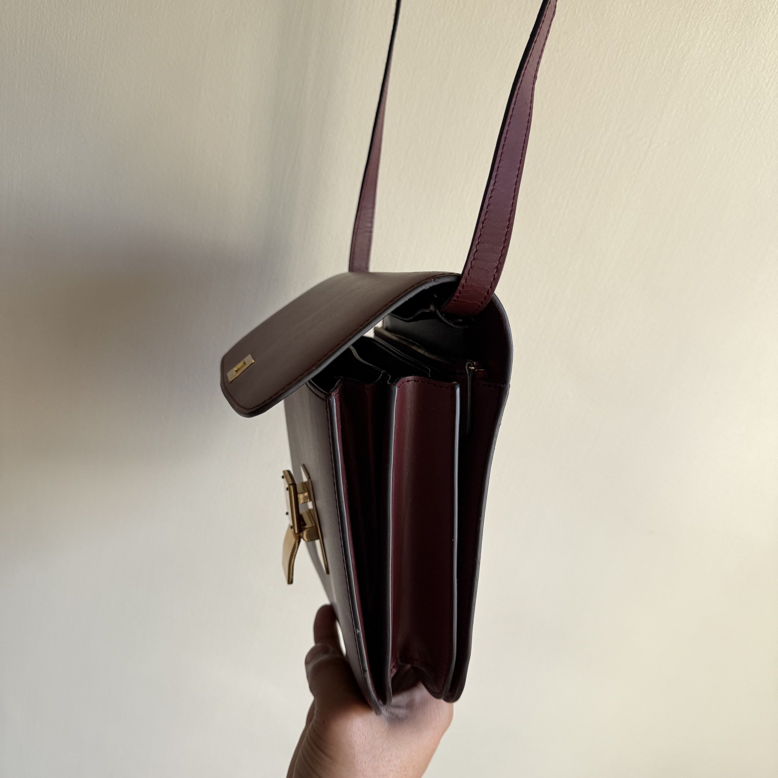 Celine Box Bag Burgundy (Category: Luxury Bags & Wallets) located in Quezon City. Submitted by toomuchpain (Listing ID 1417481043, Image 3). Description: - Authentic Celine Box Bag in Burgundy - Gold-tone clasp - Interior with multiple compartments and a zippered pocket - Marked "CELINE PARIS" inside - Made in Italy - Includes shoulder strap.