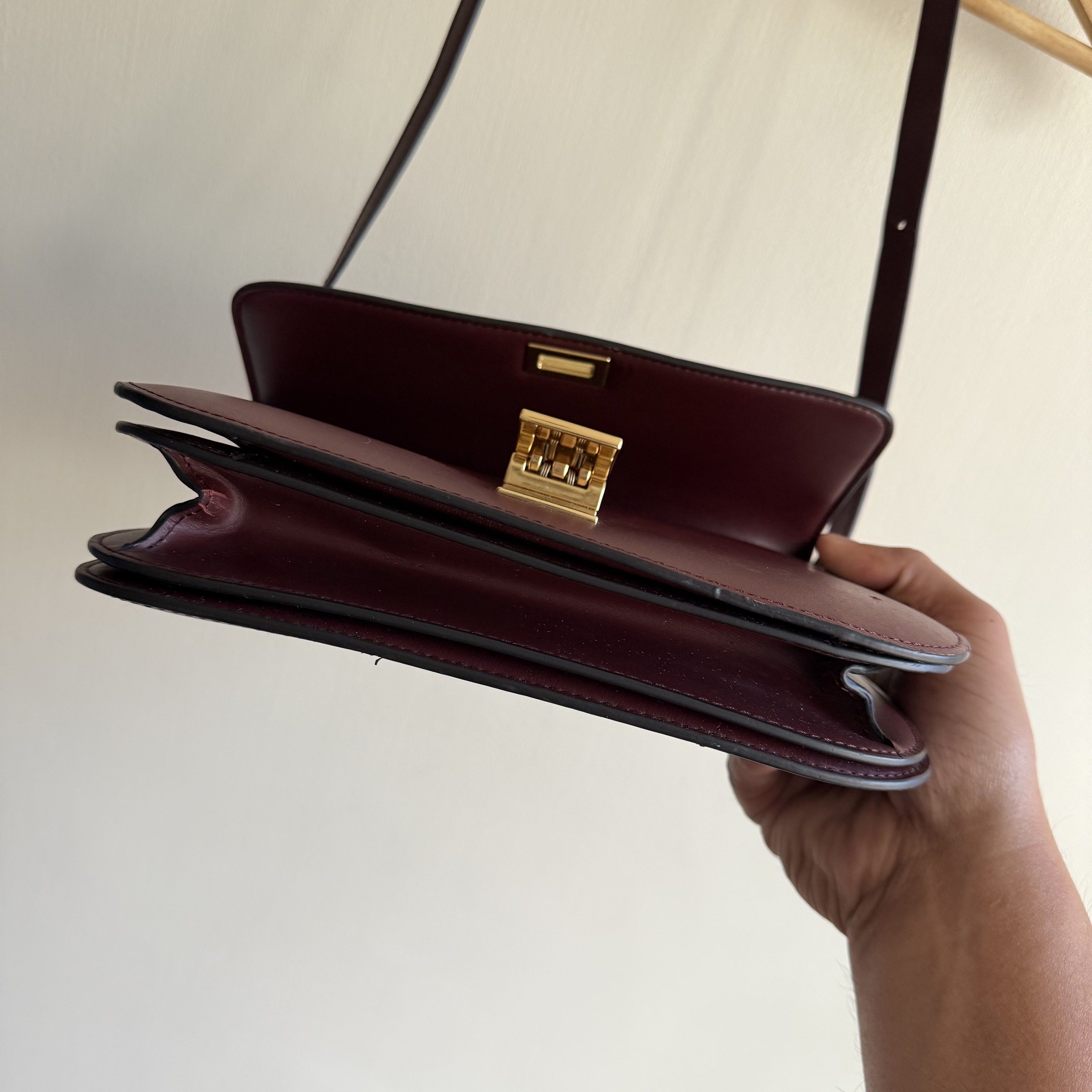 Celine Box Bag Burgundy (Category: Luxury Bags & Wallets) located in Quezon City. Submitted by toomuchpain (Listing ID 1417481043, Image 2). Description: - Authentic Celine Box Bag in Burgundy - Gold-tone clasp - Interior with multiple compartments and a zippered pocket - Marked "CELINE PARIS" inside - Made in Italy - Includes shoulder strap.