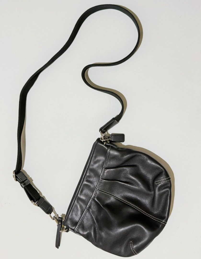 Coach Black Leather Crossbody Bag (Category: Luxury Bags & Wallets) located in Santa Rosa. Submitted by biancamarie0404 (Listing ID 1417479333, Image 1). Description: Black leather crossbody bag from Coach. Features a zip closure and a long, adjustable strap. Includes a Coach hangtag. The bag has white stitching details and silver-tone hardware. The bag has a rounded shape..