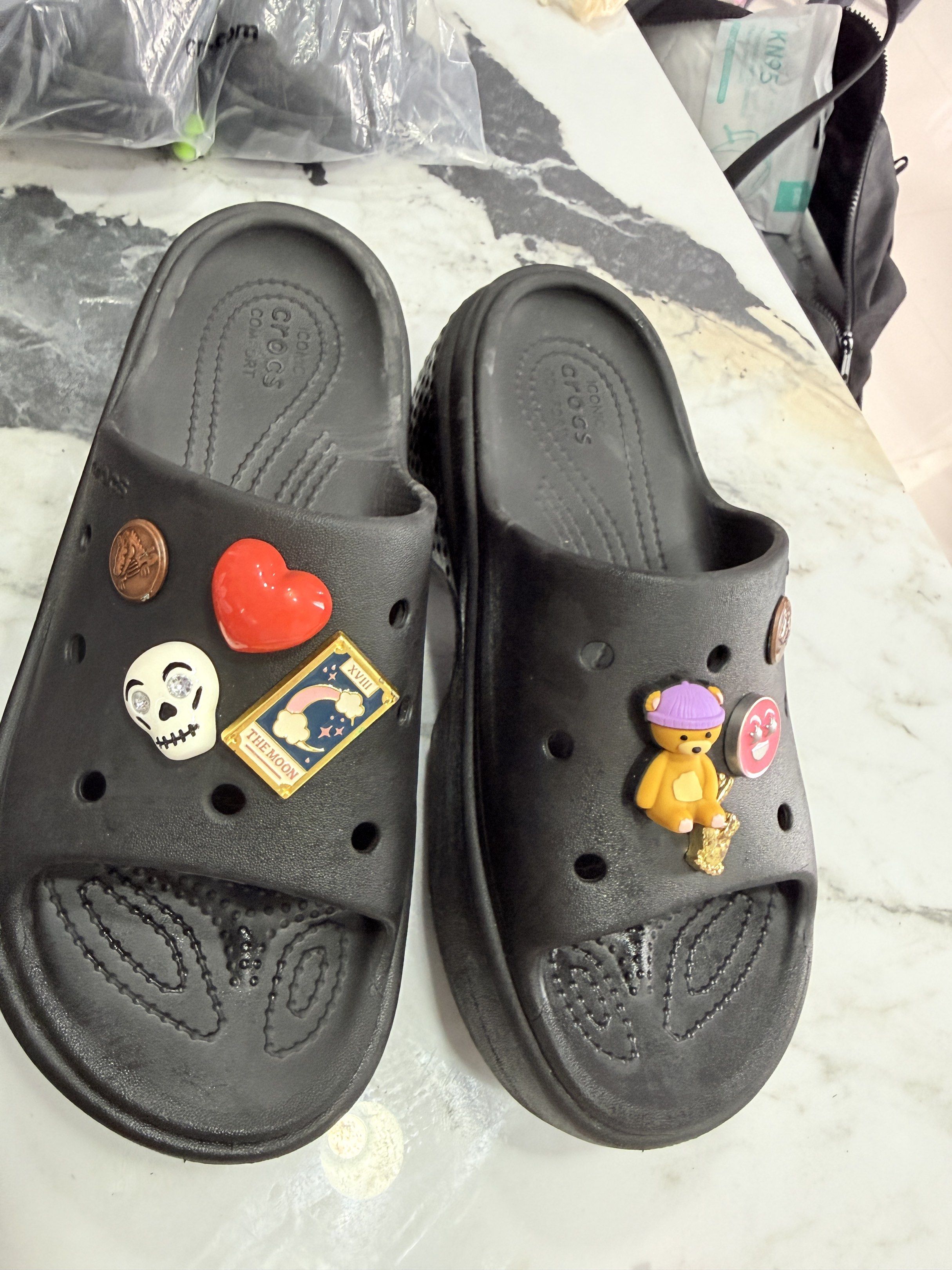 Crocs Classic Platform Slide Black (Category: Slippers and slides) located in Himamaylan. Submitted by EsClosetCleanUp (Listing ID 1417479230, Image 2). Description: - Black Crocs Classic Platform Slide sandals - Includes several Jibbitz charms - Features a platform sole - Crocs logo visible.
