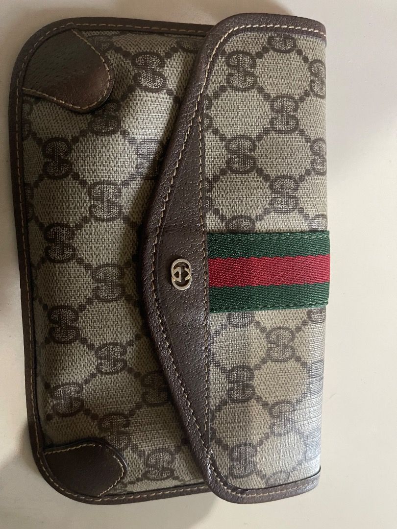 GG GUCCI Supreme Clutch (Category: Luxury Bags & Wallets) located in Quezon City. Submitted by hellopatchi (Listing ID 1417493924, Image 1). Description: - Authentic Gucci clutch - Iconic GG Supreme canvas - Signature green and red stripe - Snap closure - Light brown fabric lining - Brown leather trim - Made in Italy Clutch only.