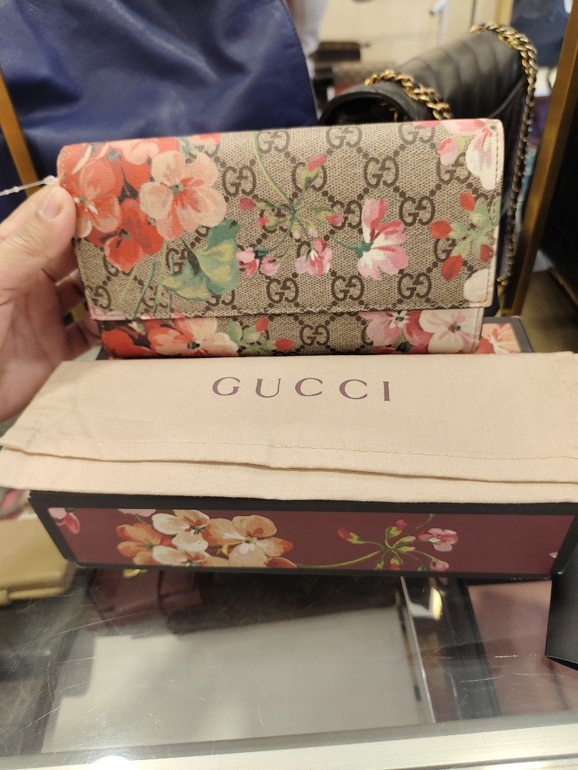 GUCCI FLORAL LONG WALLET (Category: Luxury Bags & Wallets) located in Manila. Submitted by rhian_1994 (Listing ID 1417451536, Image 1). Description: Material: Made from GG Supreme canvas, which is a material with low environmental impact, and often features leather trim. Design: It has a flap closure and a continental (long) shape. Interior: The interior typically includes multiple card slots, bill compartments, and a zippered coin pocket for org