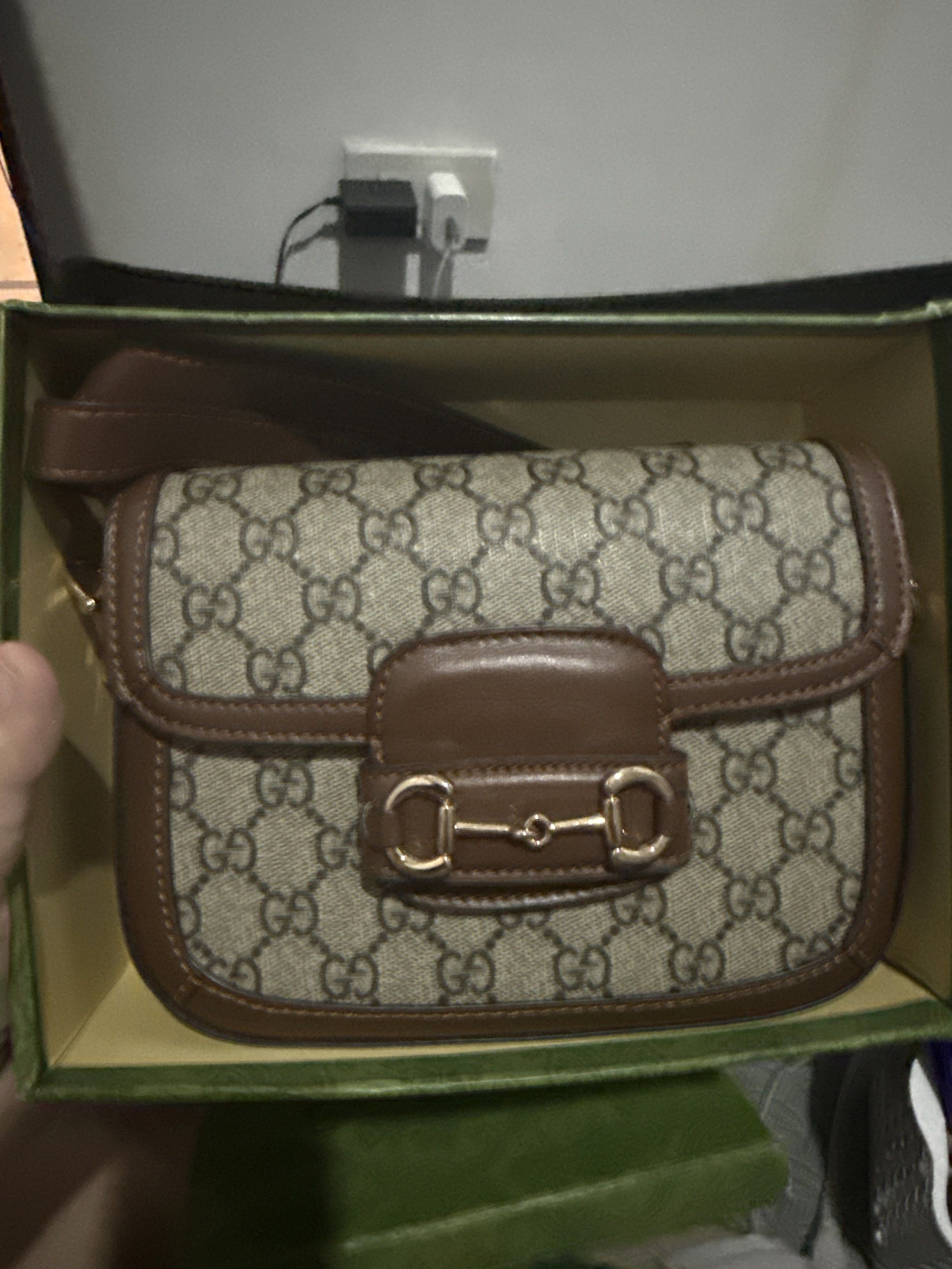 Gucci Horsebit 1955 Shoulder Bag (Category: Luxury Bags & Wallets) located in Manila. Submitted by decluttering03 (Listing ID 1417517348, Image 1). Description: - Gucci Horsebit 1955 Shoulder Bag - Iconic GG monogram canvas - Brown leather trim - Gold-toned Horsebit detail - Includes Gucci box - Flap closure and shoulder strap - Classic and stylish design.