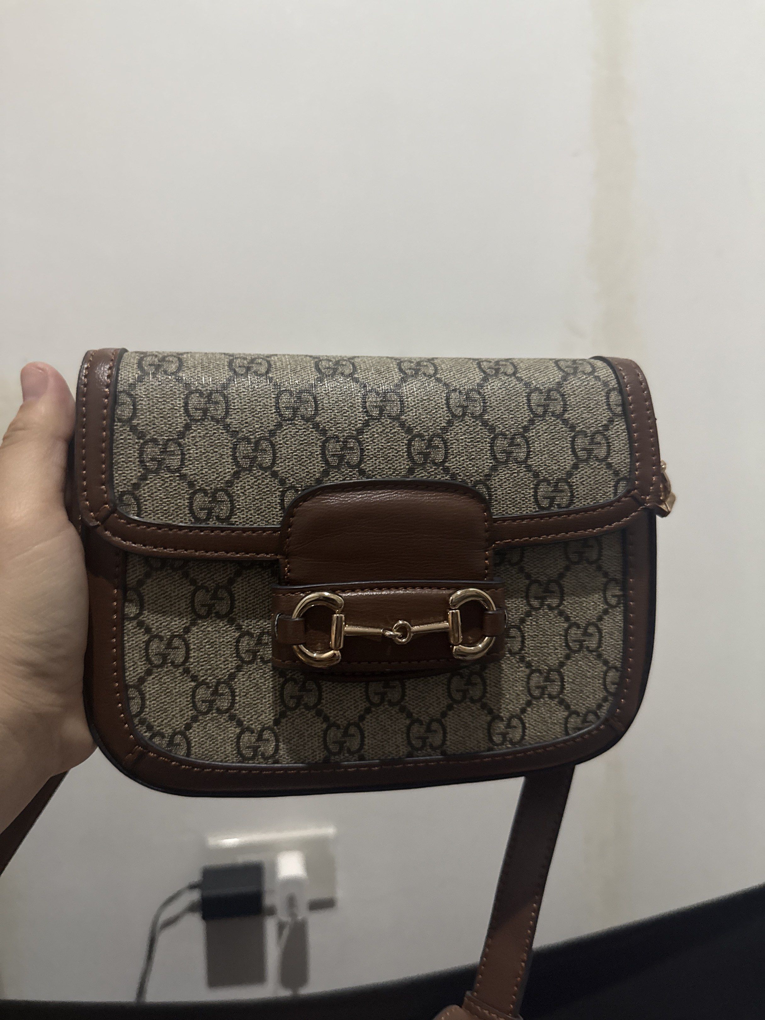 Gucci Horsebit 1955 Shoulder Bag (Category: Luxury Bags & Wallets) located in Manila. Submitted by decluttering03 (Listing ID 1417517348, Image 3). Description: - Gucci Horsebit 1955 Shoulder Bag - Iconic GG monogram canvas - Brown leather trim - Gold-toned Horsebit detail - Includes Gucci box - Flap closure and shoulder strap - Classic and stylish design.