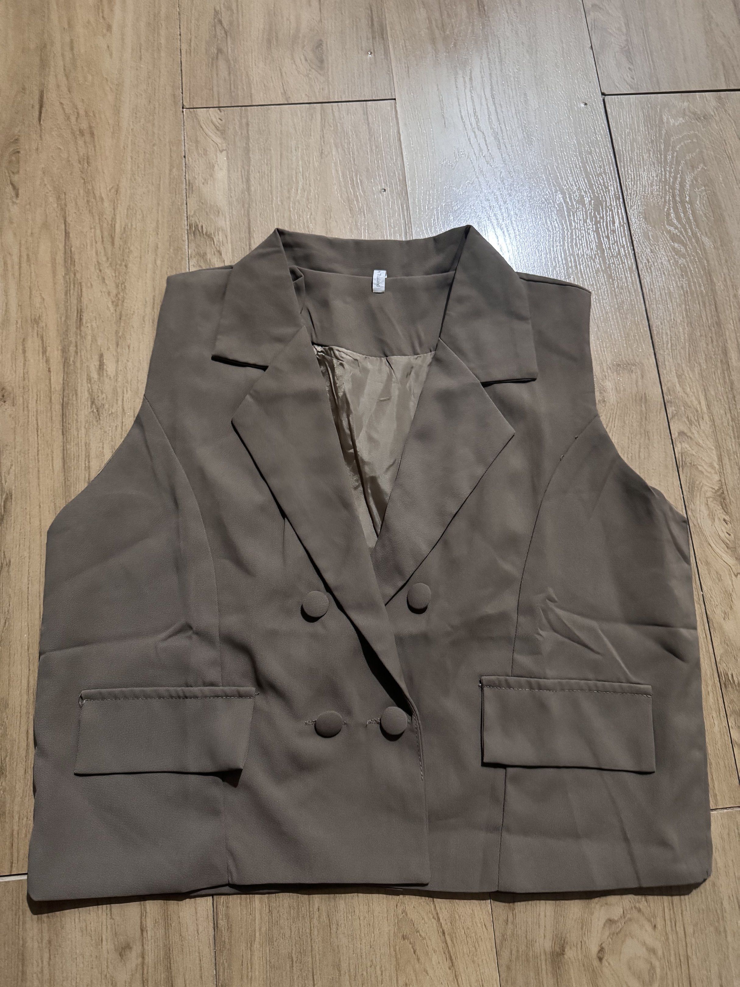 High Quality Double-Breasted Vest (Category: Others Tops) located in Quezon City. Submitted by decluttrqueen (Listing ID 1417547197, Image 1). Description: - Dark brown Double-breasted vest - Classic lapel design - Sleeveless - Perfect for layering - Versatile for casual and formal occasions - Large size ( 40 inches bust | 18 inches length) RFS: Wrong size Location: Quezon City.