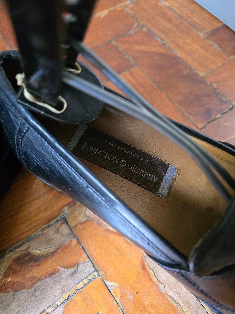 Johnston & Murphy Black Leather Tassel Loafers (Category: Dress Shoes) located in Quezon City. Submitted by quirkfox77 (Listing ID 1417582453, Image 2). Description: Classic black leather loafers from Johnston & Murphy. Features a tassel design and a slip-on style. The shoes have a leather sole and a cushioned insole. The size is 7.5 M. The shoes appear to be well-maintained and ready for wear. Perfect for both formal and casual occasions..