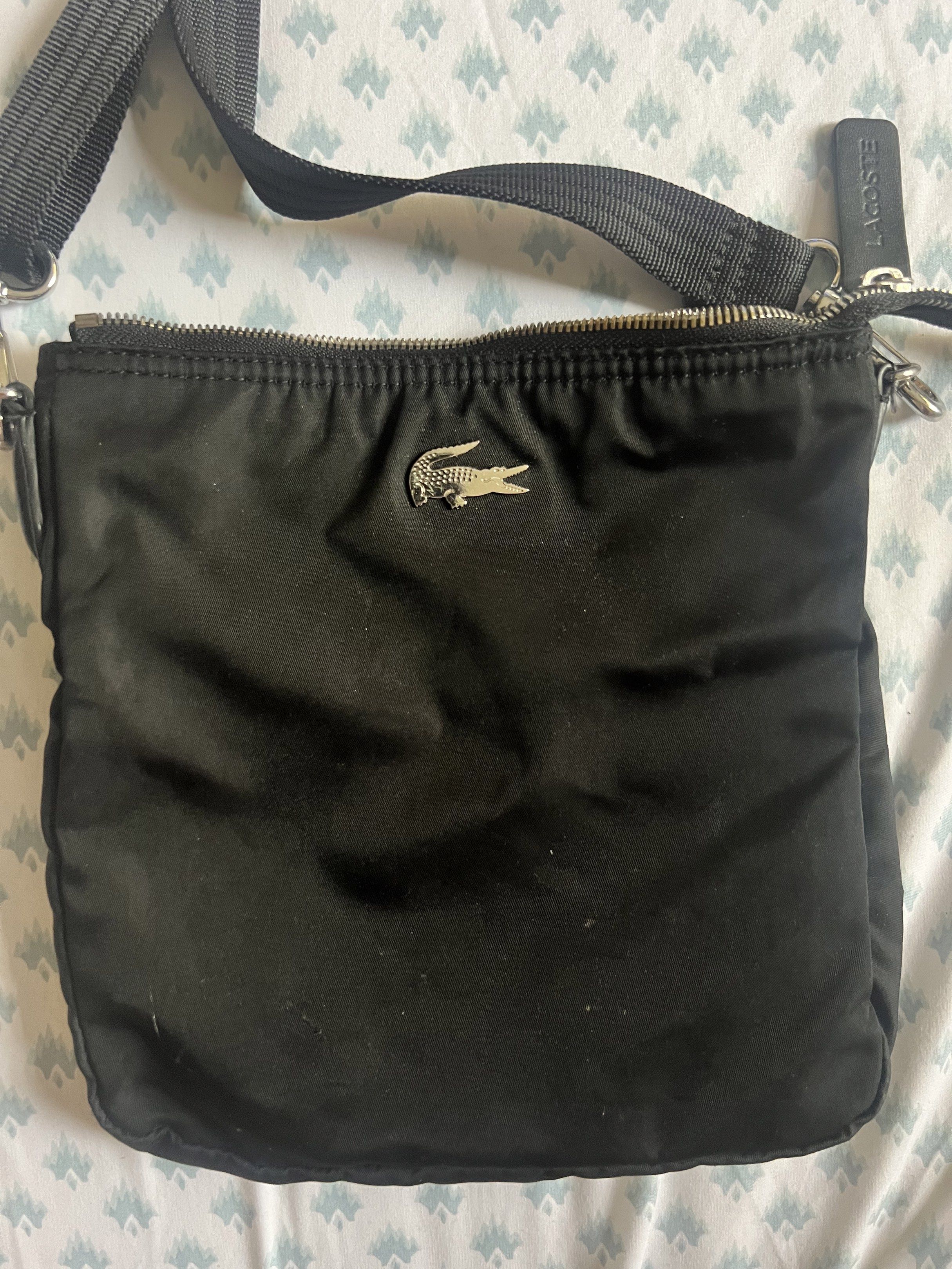 Lacoste Black Crossbody Bag (Category: Cross-body Bags) located in Rizal. Submitted by ichaaay21 (Listing ID 1417483803, Image 2). Description: 💯 authentic LACOSTE BLACK NYLON CROSSBODY BAG - 1 main compartment, 1 inner pocket - Got this from LACOSTE ROYAL DUTY FREE SUBIC BRANCH - Malinis pa. And not amoy tago/molds - AS IS. NO MORE PAPER BAG. BAG ONLY! ❗️ will not go lower than the posted price. ❗️ ❗️ low ballers who can’t afford will be BLOCKE