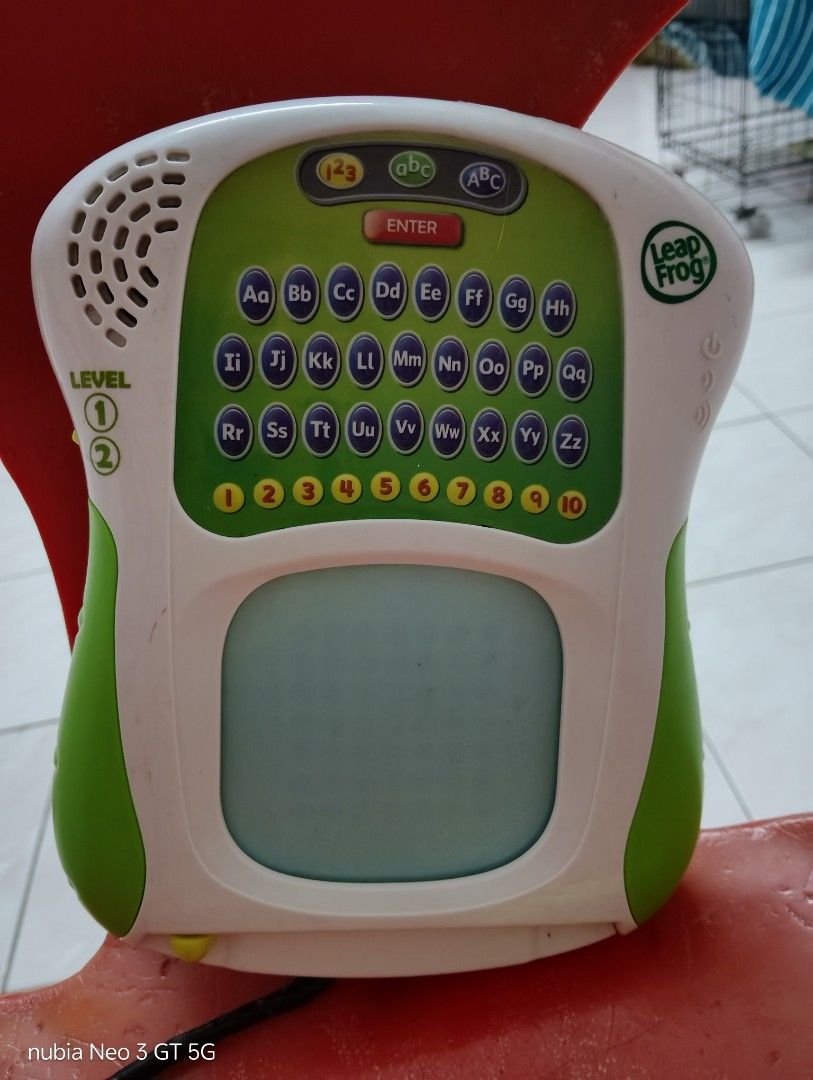 LeapFrog Scribble & Write (Category: Educational & Learning Toys) located in Klang. Submitted by michell40 (Listing ID 1417576654, Image 3). Description: - LeapFrog Scribble & Write educational toy. - Features a screen for writing practice. - Includes an alphabet keyboard and number buttons. - Comes with an attached stylus. - Offers two learning level settings. - Color: Green and white..