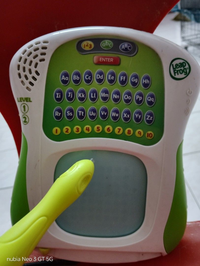LeapFrog Scribble & Write (Category: Educational & Learning Toys) located in Klang. Submitted by michell40 (Listing ID 1417576654, Image 2). Description: - LeapFrog Scribble & Write educational toy. - Features a screen for writing practice. - Includes an alphabet keyboard and number buttons. - Comes with an attached stylus. - Offers two learning level settings. - Color: Green and white..