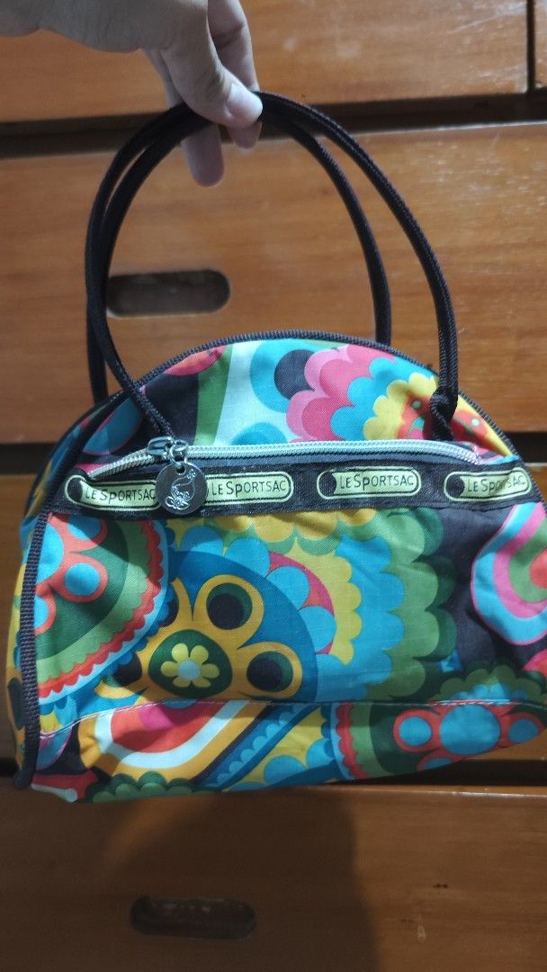 LeSportsac Handbag (Category: Shoulder Bags) located in Cavite. Submitted by nesstuffandeverything (Listing ID 1417476300, Image 1). Description: - LeSportsac handbag - Unique floral pattern - Top zipper closure - Two handles - Black trim - Small logo detail - Stylish and compact.