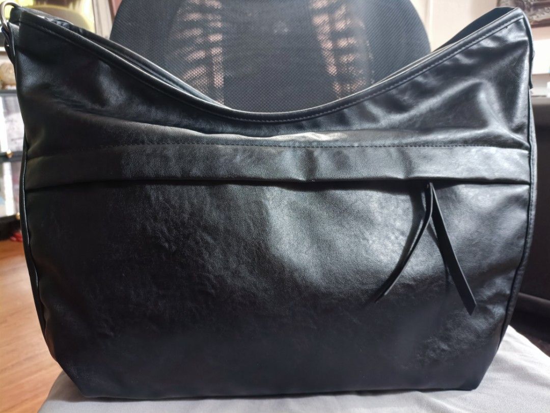 Maison Mined Black Shoulder Bag (Category: Luxury Bags & Wallets) located in Manila. Submitted by jjm-collections (Listing ID 1417426324, Image 1). Description: - Black Maison Mined shoulder bag - Sleek design - Multiple compartments - Zippered side pocket - Interior pockets - Mesh pocket inside - Zippered pocket inside - Made from polyurethane - Long strap for shoulder wear - Zipper closure -12"heightx 17.8" width.