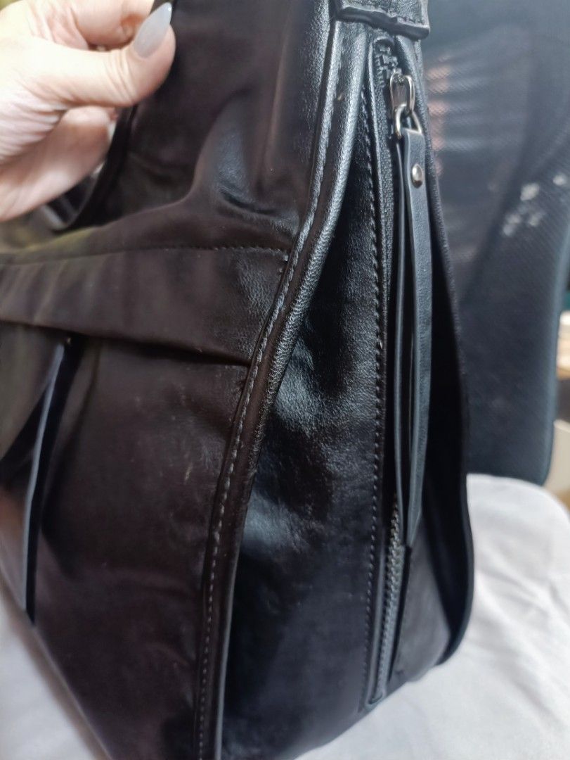 Maison Mined Black Shoulder Bag (Category: Luxury Bags & Wallets) located in Manila. Submitted by jjm-collections (Listing ID 1417426324, Image 2). Description: - Black Maison Mined shoulder bag - Sleek design - Multiple compartments - Zippered side pocket - Interior pockets - Mesh pocket inside - Zippered pocket inside - Made from polyurethane - Long strap for shoulder wear - Zipper closure -12"heightx 17.8" width.
