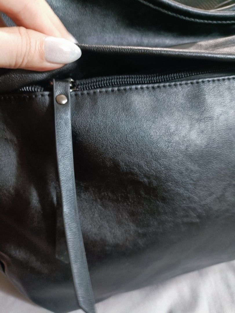 Maison Mined Black Shoulder Bag (Category: Luxury Bags & Wallets) located in Manila. Submitted by jjm-collections (Listing ID 1417426324, Image 3). Description: - Black Maison Mined shoulder bag - Sleek design - Multiple compartments - Zippered side pocket - Interior pockets - Mesh pocket inside - Zippered pocket inside - Made from polyurethane - Long strap for shoulder wear - Zipper closure -12"heightx 17.8" width.