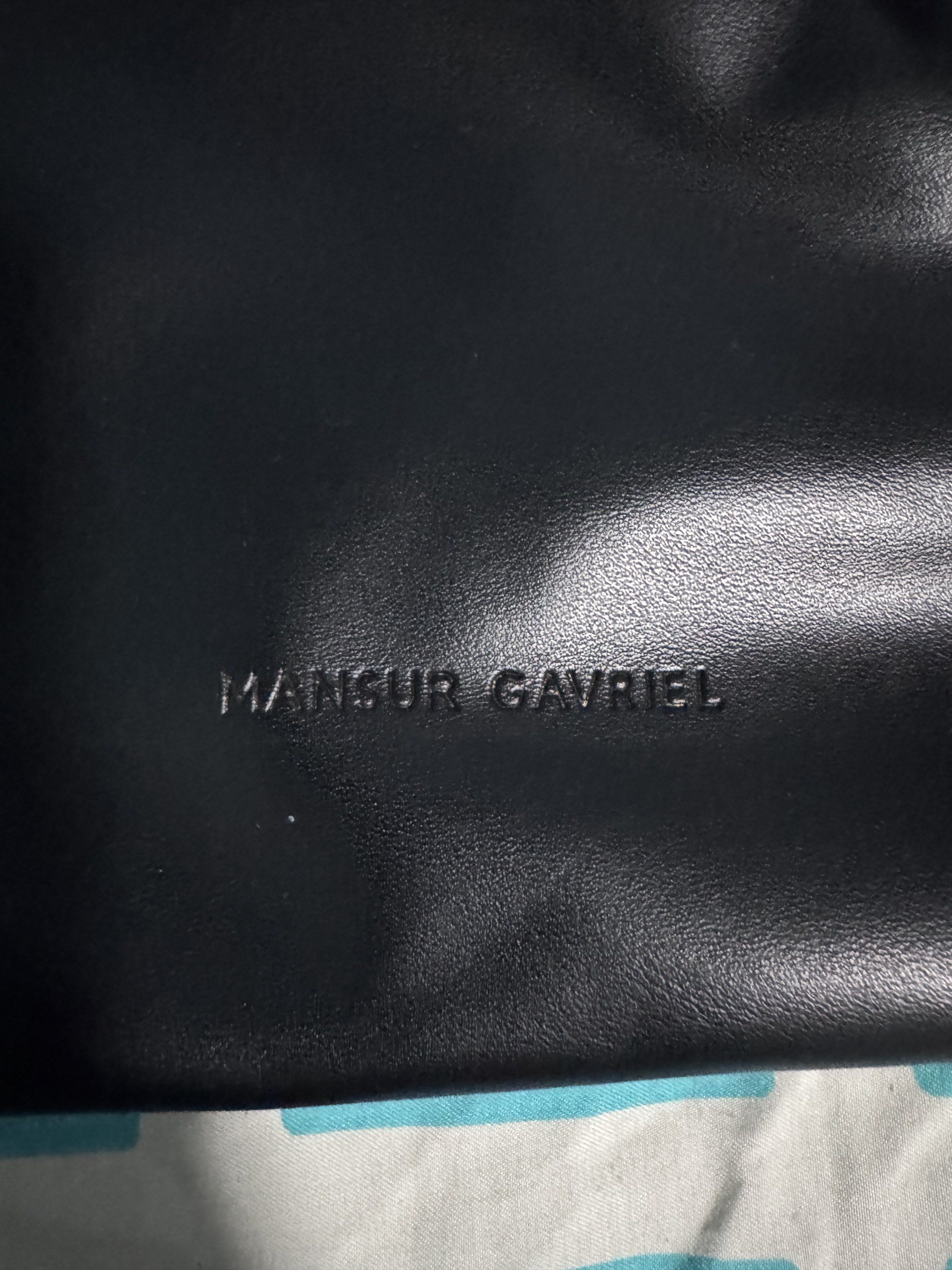 Mansur Gavriel Black Bucket Bag (Category: Luxury Bags & Wallets) located in Quezon City. Submitted by candyclosetph (Listing ID 1417512083, Image 2). Description: - Mansur Gavriel black bucket bag - Drawstring closure - Red interior - Adjustable shoulder strap - Made of leather - Dimensions: Approximately 10" width x 11" height.