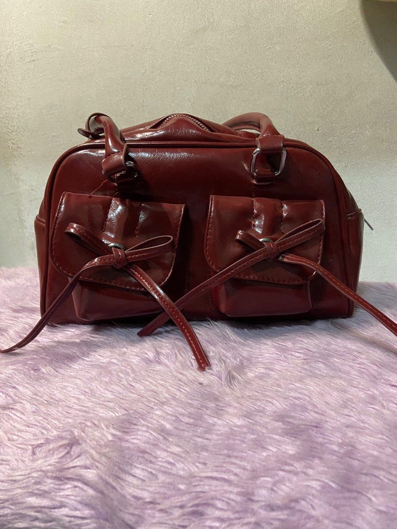 Maroon Bow Detail Handbag (Category: Luxury Bags & Wallets) located in Manila. Submitted by closet.by.ika (Listing ID 1417502916, Image 1). Description: Cherry red bag for sale!! - never been used tambak lang sa bahay 😭 - good as new 📍caloocan/malabon .