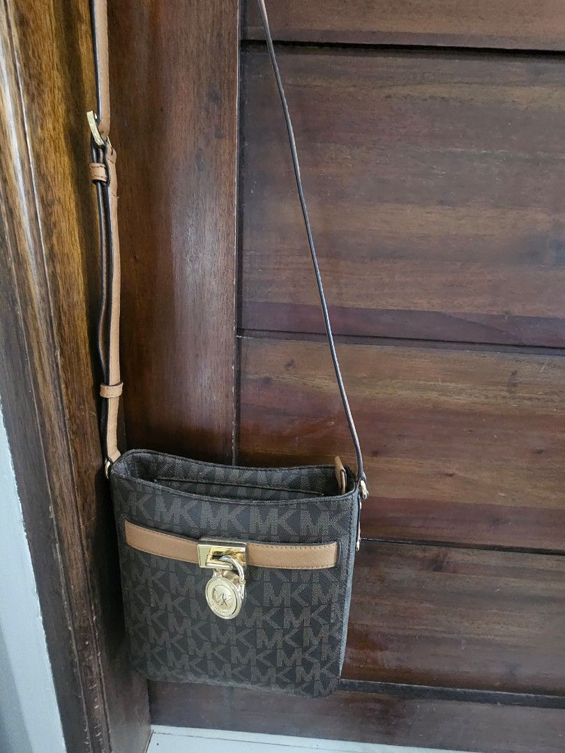 Michael Kors Crossbody Bag (Category: Luxury Bags & Wallets) located in Caloocan City. Submitted by cecilleuy648-00384 (Listing ID 1417453970, Image 1). Description: - Michael Kors crossbody bag - Brown monogram pattern - Tan strap and accents - Gold-tone lock closure - Adjustable strap for shoulder or crossbody wear - Compact design - Ideal for everyday use.