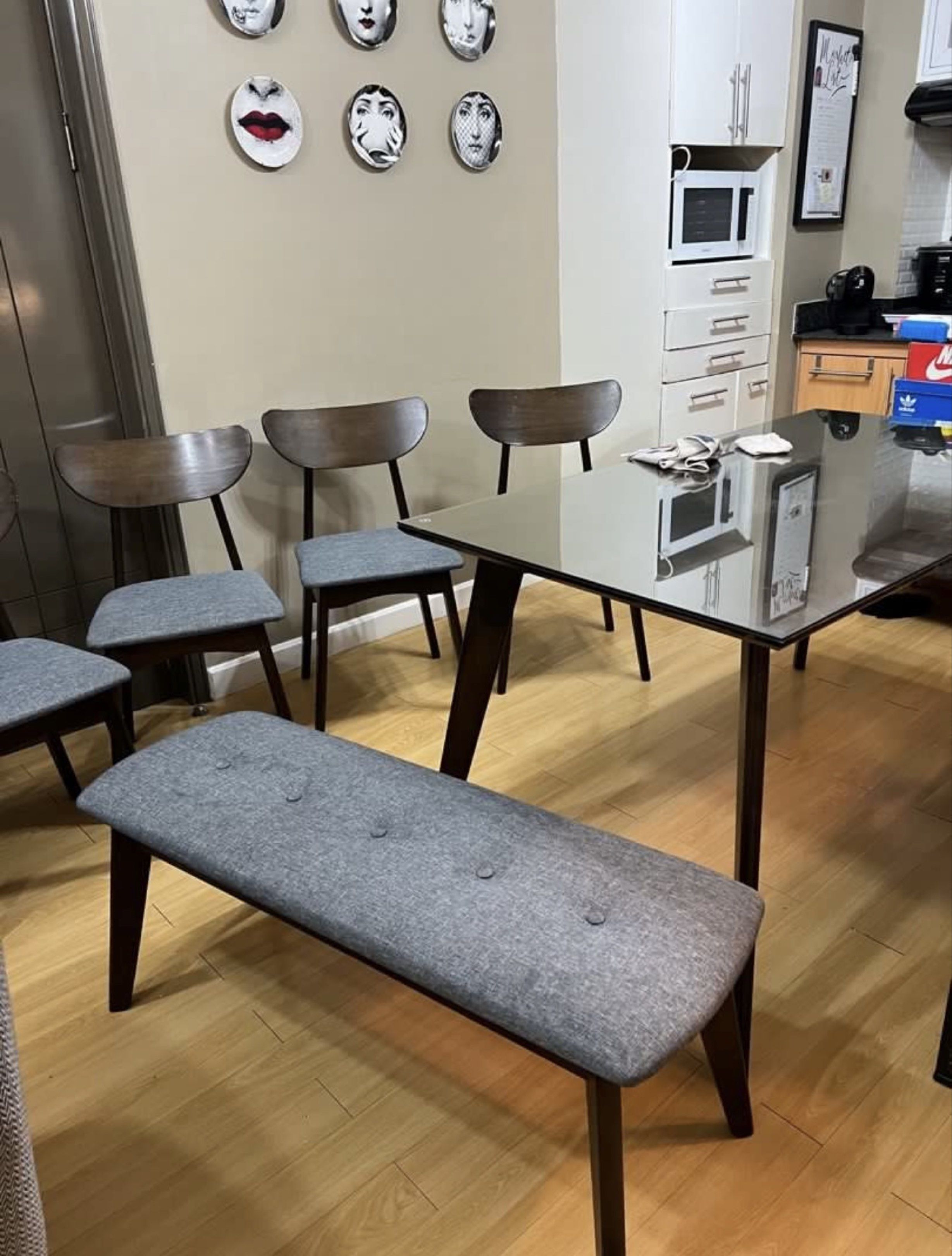 Mid-Century Modern Dining Table Set (Category: Tables & Sets) located in Manila. Submitted by epn_sale (Listing ID 1417502724, Image 3). Description: - Mid-century modern dining set - Includes: Rectangular table, 4 chairs, and bench - Table: Dark wood finish with glass top - Chairs and bench: Gray upholstered seats - Seats up to 6 people - glass top worth 8k sold separately but will give it for free - no scratches, no bumps, no smell .
