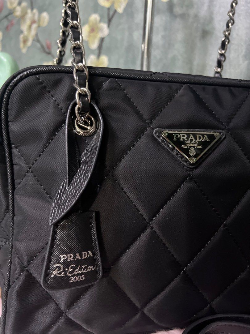 RUSH!!Prada Re-Edition 2005 Quilted Shoulder Bag (Category: Luxury Bags & Wallets) located in Quezon City. Submitted by sherashley (Listing ID 1417510489, Image 2). Description: - Prada Re-Edition 2005 shoulder bag - Color: Black - Design: Quilted - Straps: Chain and detachable long strap - Closure: Zipper - Includes: Prada tag, Made in Italy label -w/dustbag & box NOTE: bought this fr a live seller at a thrift store in Japan. The seller stated t