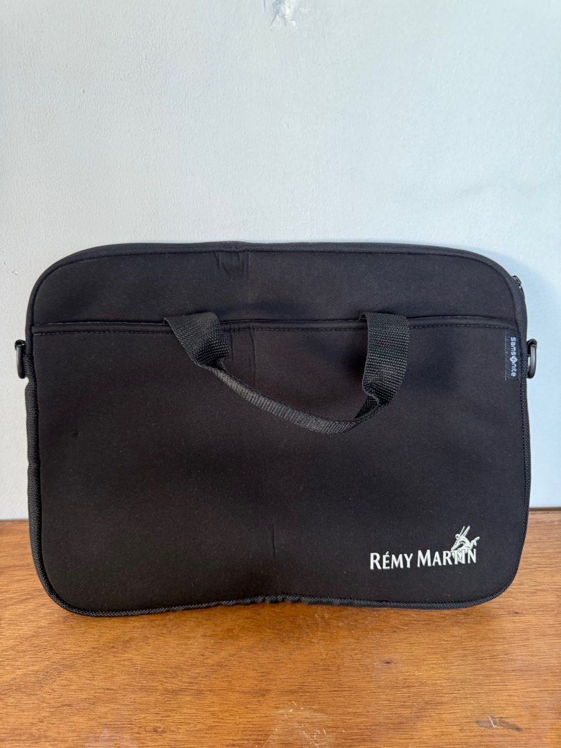 Samsonite Remy Martin Laptop Bag (Category: Laptop Bags & Sleeves) located in Paranaque City. Submitted by garagesale0 (Listing ID 1417500050, Image 1). Description: - Black Samsonite laptop bag - Features Remy Martin logo - Includes top handle and shoulder strap - Multiple interior compartments.