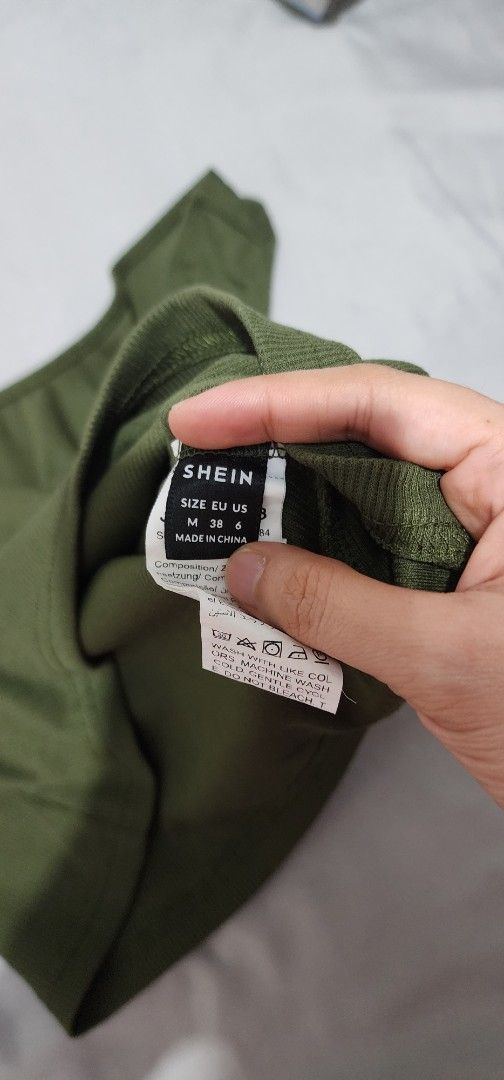 Shein One Shoulder Top (Category: Sleeveless) located in Imus. Submitted by sashafame (Listing ID 1417548496, Image 2). Description: - Shein olive green one-shoulder top - Ribbed texture - Size: M (EU 38, US 6) - Includes black straps - Made in China.