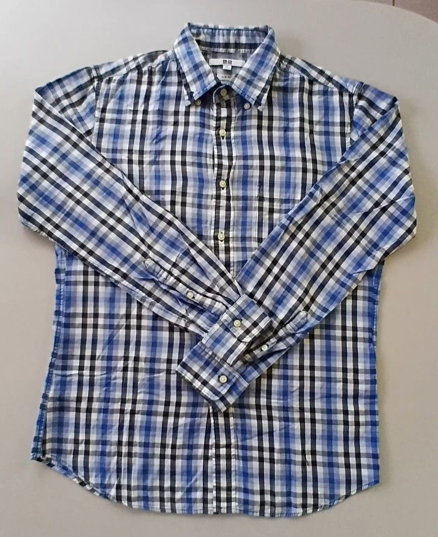 Uniqlo Slim Fit Checkered Shirt - Medium (Category: Tshirts & Polo Shirts ) located in Daet. Submitted by frendachichi (Listing ID 1417466911, Image 1). Description: - Uniqlo Slim Fit Checkered Shirt Preloved, Excellent condition - Color: Blue, Black, and White - Size: Medium - Features a button-down collar - Long sleeves with buttoned cuffs - Classic checkered pattern - Made in China Actual Measurement: Shoulder - 16 inches Chest - 20 inches Len