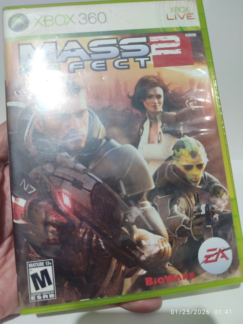 XBOX 360 - Mass Effect 2 (PRE-OWNED) "OPEN REGION" (Category: Xbox) located in Mendez-Nunez. Submitted by sf2_gameshop (Listing ID 1417491861, Image 2). Description: PLEASE READ Open region, the disc will work on any Xbox 360 unit regardless of region. PAL - √ (Yes) NTSC/J - √ (Yes) NTSC - √ (Yes) CONDITION: Pre-owned item.Tested working. Both discs are in good condition. It comes with a game manual and inserts. GENRE: Action role-playing, third 