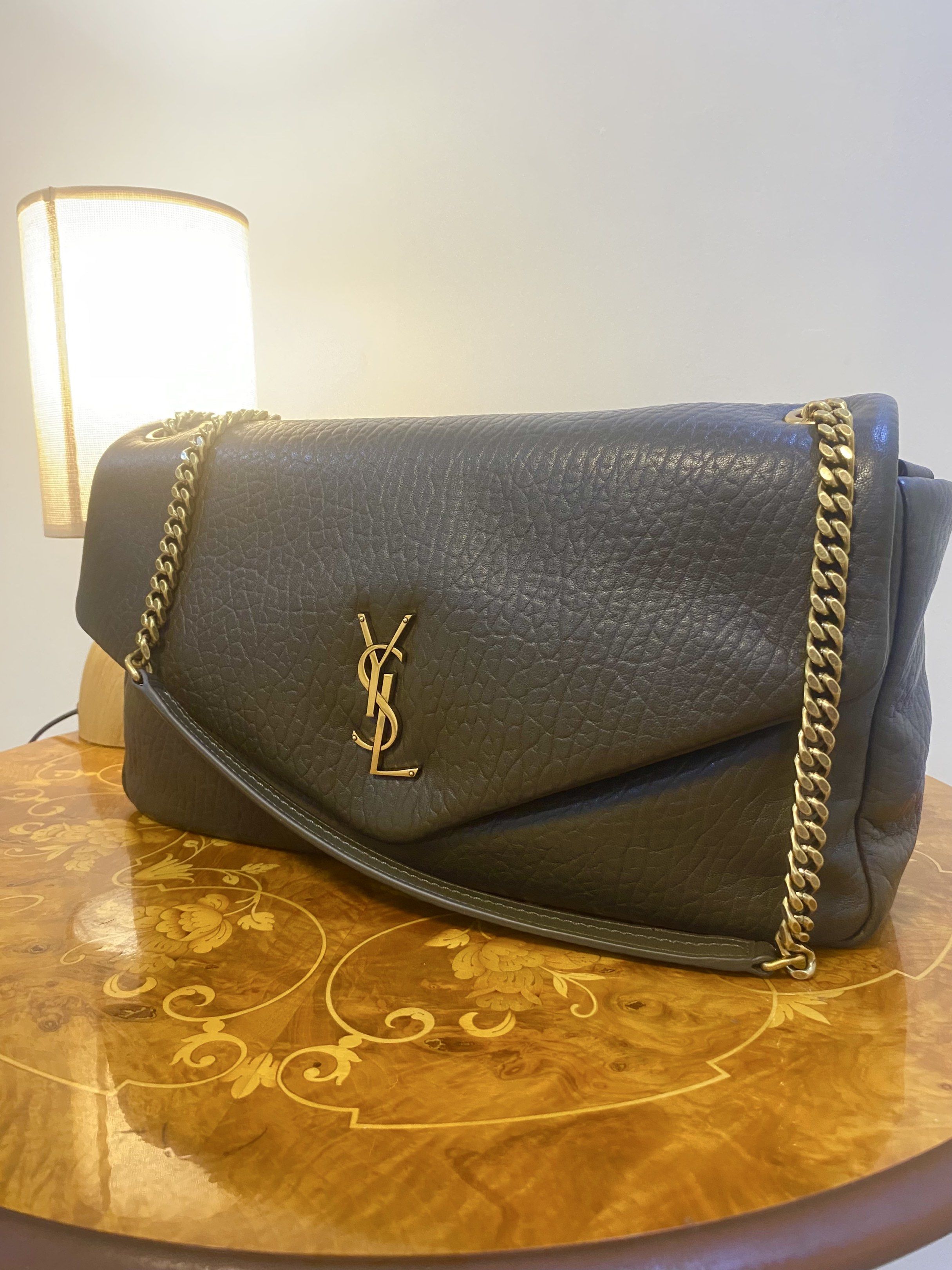 YSL Sling bag crossbody bag (Category: Luxury Bags & Wallets) located in Silang. Submitted by girlyouneedthis (Listing ID 1417461750, Image 2). Description: YSL Calypso large in this beautiful textured green genuine leather. Very spacious, can be sling bag and a crossbody bag. Coded, Comes with dustbag only. Size Height 23 CM Width 35 CM.