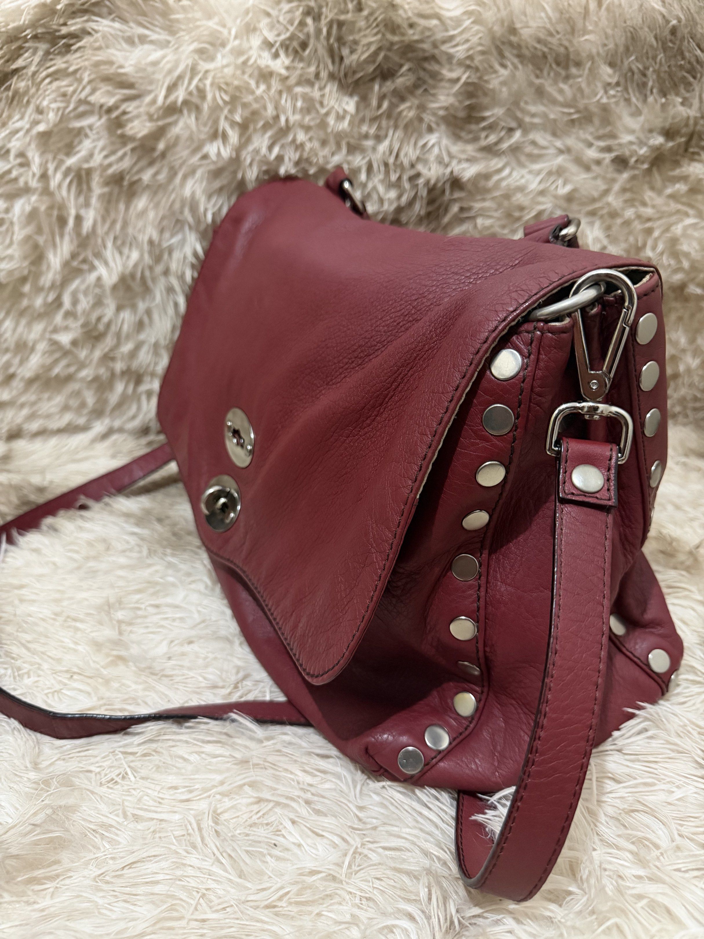 Zanellato Postina Large (Category: Luxury Bags & Wallets) located in Puerto Princesa. Submitted by betz0921 (Listing ID 1417562052, Image 3). Description: - Authentic Zanellato Two Way Bag - Rich burgundy leather exterior - Top handle and detachable shoulder strap - Flap closure with turn-lock - Silver-tone stud accents - Beige fabric lining - Multiple interior compartments - Includes a zippered pocket .