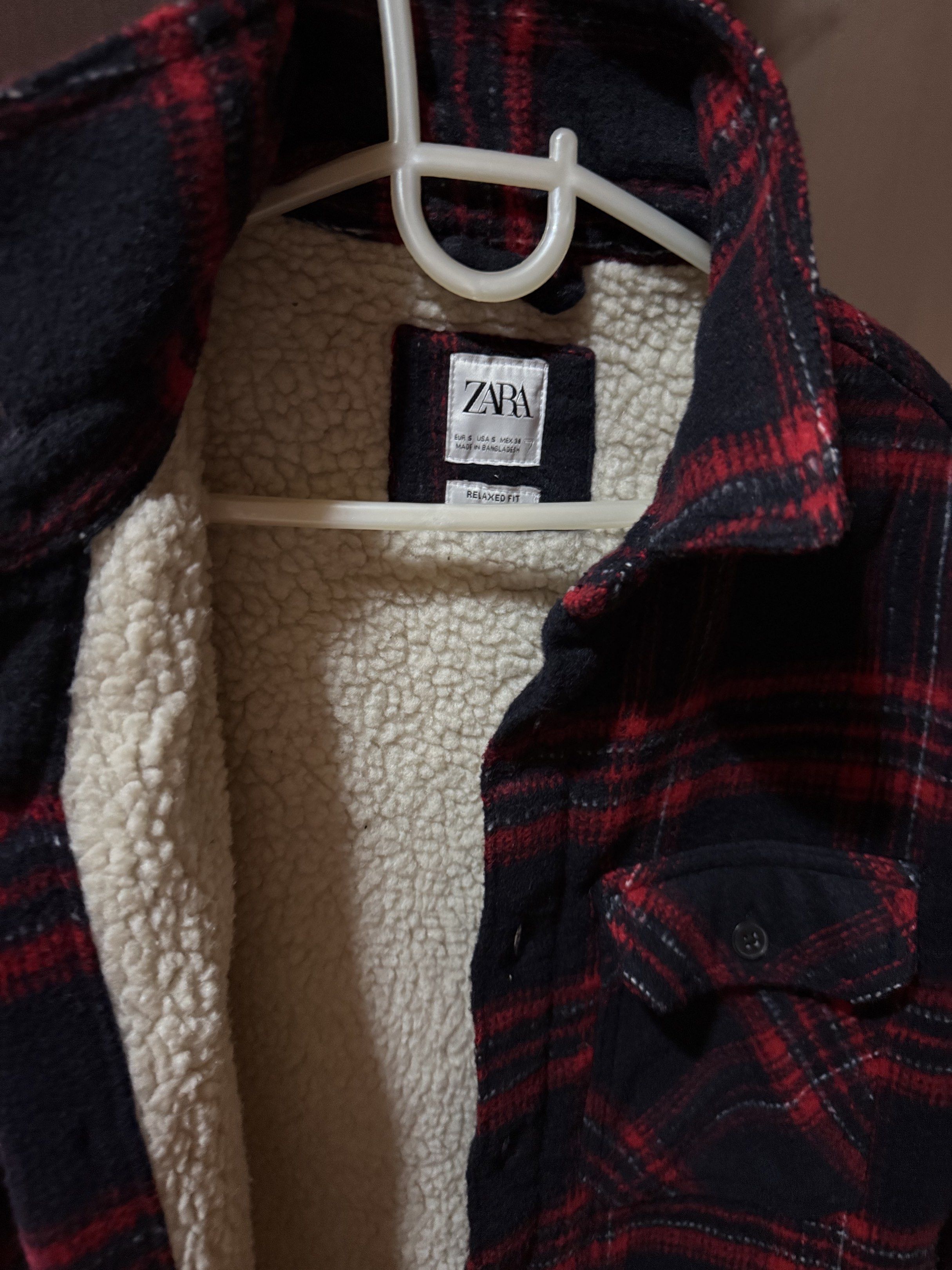 Zara Plaid Sherpa Lined Jacket (Category: Coats, Jackets and Outerwear) located in Quezon City. Submitted by pathdz (Listing ID 1417433195, Image 2). Description: - Zara plaid jacket - Red and navy color - Warm sherpa lining - Two chest pockets - Button-up closure - Size tag visible - Perfect for cooler weather.