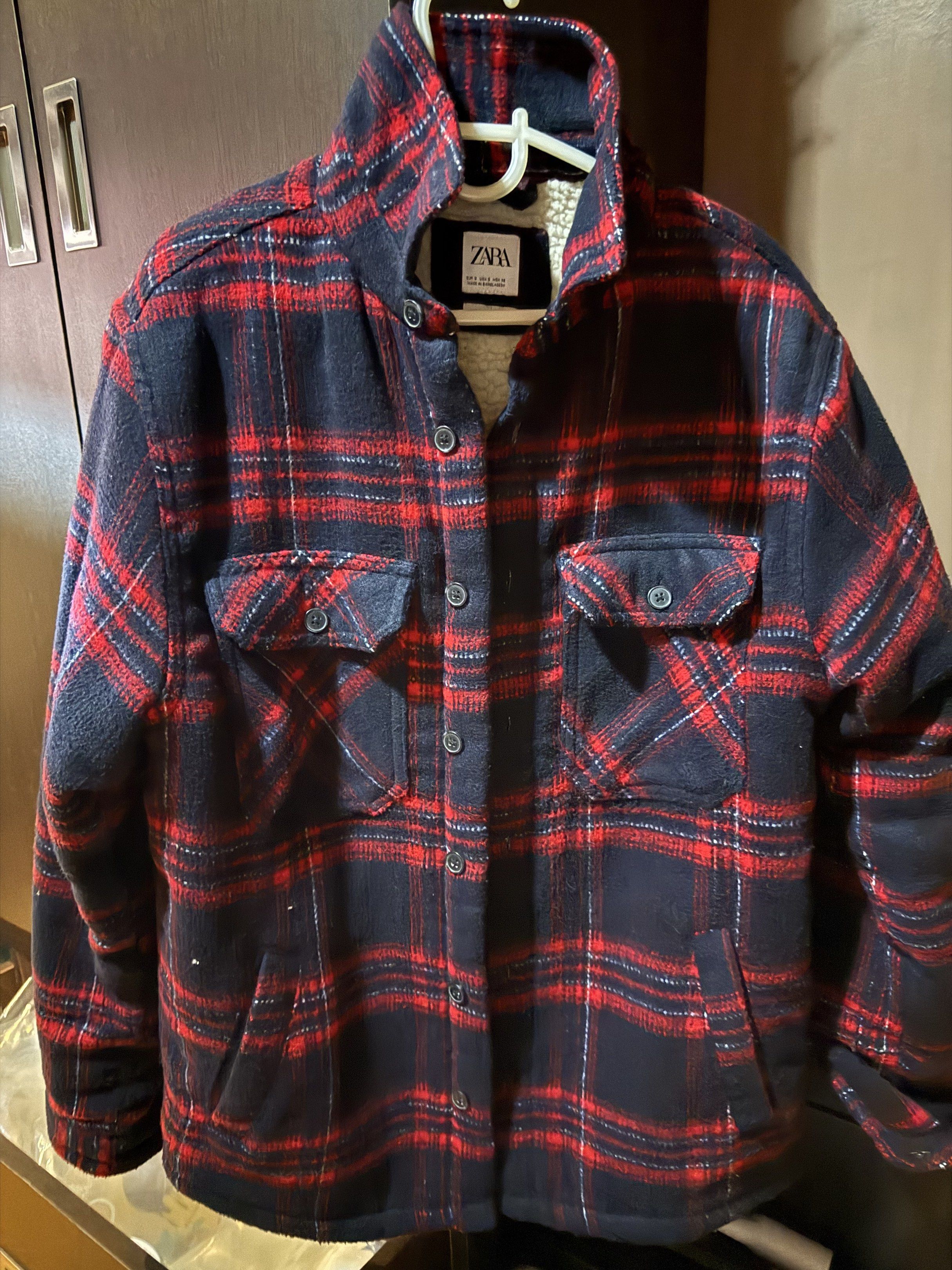 Zara Plaid Sherpa Lined Jacket (Category: Coats, Jackets and Outerwear) located in Quezon City. Submitted by pathdz (Listing ID 1417433195, Image 1). Description: - Zara plaid jacket - Red and navy color - Warm sherpa lining - Two chest pockets - Button-up closure - Size tag visible - Perfect for cooler weather.