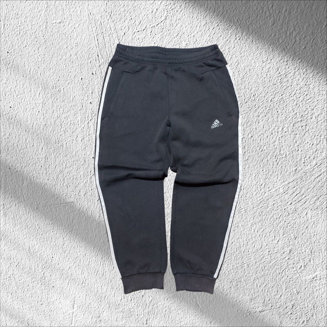Adidas Black Sweatpants with White Stripes (Category: Other Bottoms) located in Manila. Submitted by anthonig (Listing ID 1417790481, Image 1). Description: - Adidas sweatpants in classic black. - White stripes down the sides. - Small Adidas logo on the front. - Secure zippered pockets. - Comfortable elasticated waistband. - Ribbed cuffs for a snug fit. - Tag is visible..