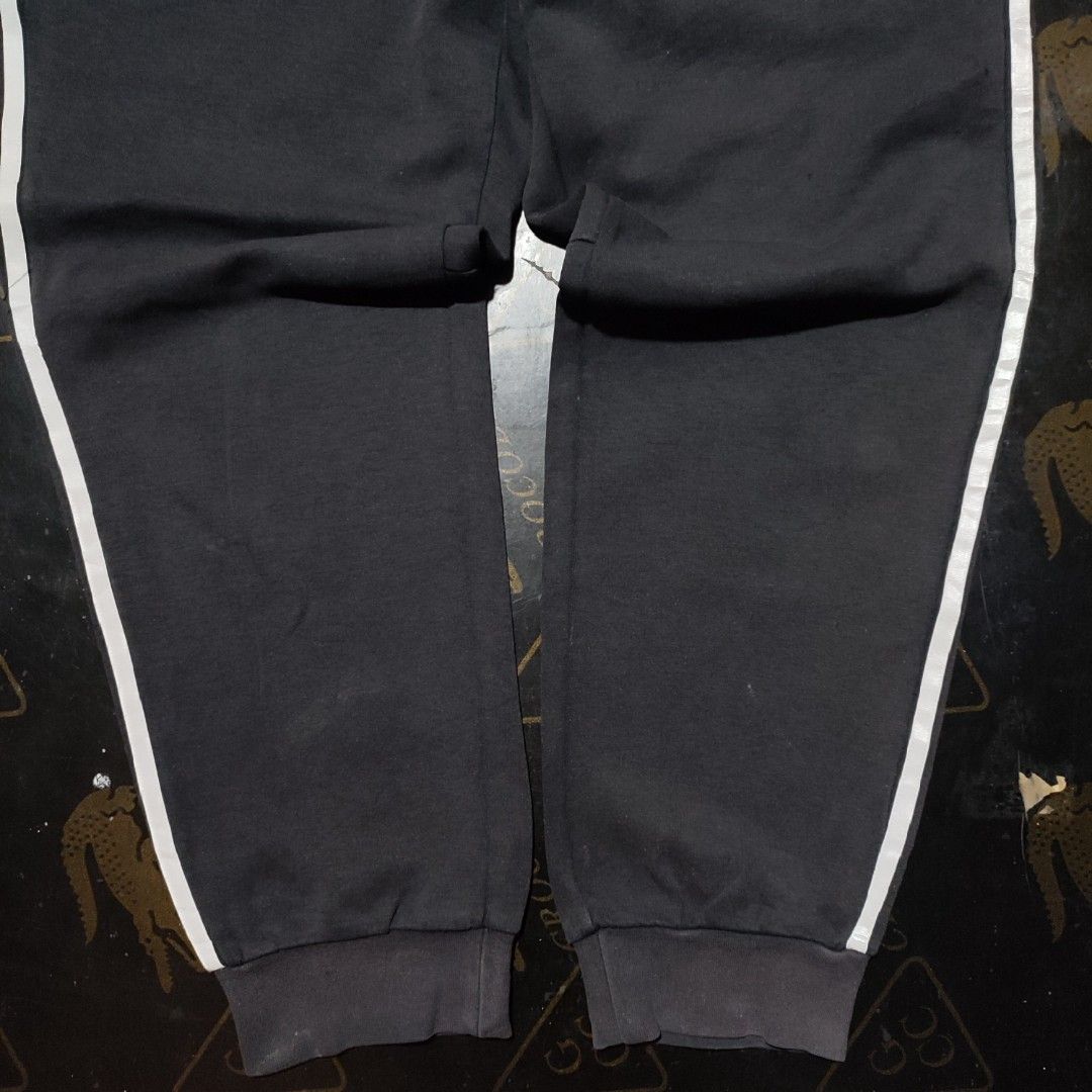 Adidas Black Sweatpants with White Stripes (Category: Other Bottoms) located in Manila. Submitted by anthonig (Listing ID 1417790481, Image 3). Description: - Adidas sweatpants in classic black. - White stripes down the sides. - Small Adidas logo on the front. - Secure zippered pockets. - Comfortable elasticated waistband. - Ribbed cuffs for a snug fit. - Tag is visible..