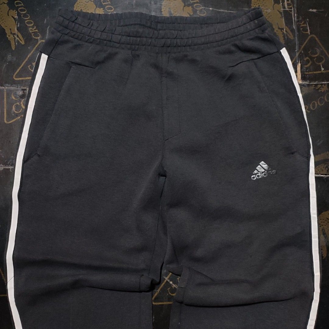 Adidas Black Sweatpants with White Stripes (Category: Other Bottoms) located in Manila. Submitted by anthonig (Listing ID 1417790481, Image 2). Description: - Adidas sweatpants in classic black. - White stripes down the sides. - Small Adidas logo on the front. - Secure zippered pockets. - Comfortable elasticated waistband. - Ribbed cuffs for a snug fit. - Tag is visible..