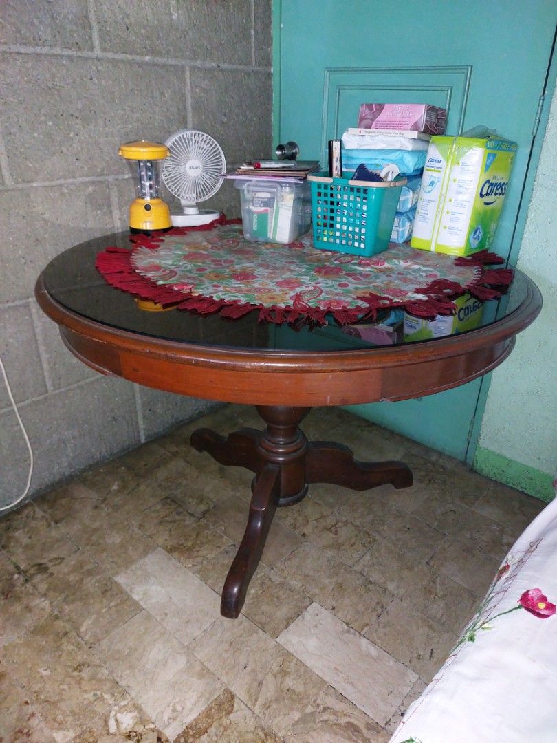 Antique Round Wooden Coffee Table with Drawer (Category: Tables & Sets) located in Makati City. Submitted by noel12 (Listing ID 1417637460, Image 1). Description: - Antique Round coffee table - Dark wooden finish - Features a drawer for storage - Unique carved pedestal base - Includes a round glass top - Ideal for living rooms and lounges - Classic and sophisticated design - Size: 46"diameter x 31"height - pls inquire at 0917-8090821 for further 