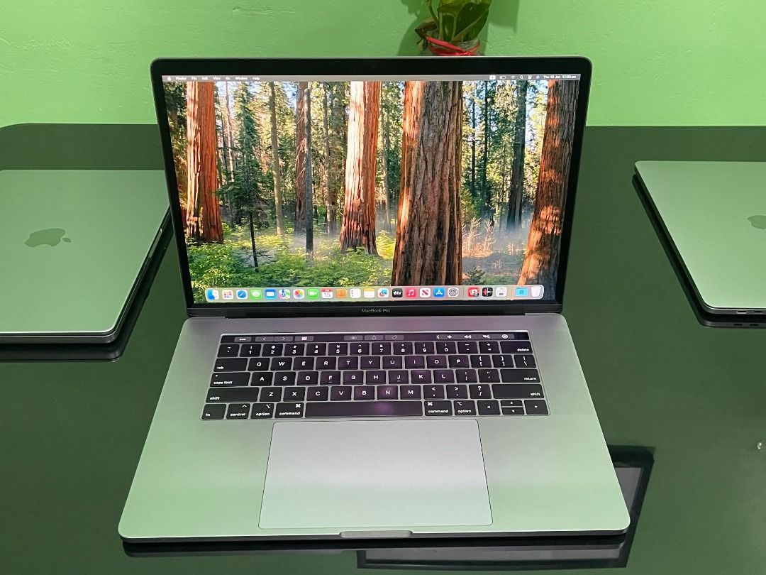Apple MacBook Pro i7 ( 2019 ) 13 inch touch bar (Category: Laptops & Notebooks) located in Pasay City. Submitted by janrickz (Listing ID 1417759461, Image 2). Description: - Apple MacBook Pro i7 13-inch Touch bar - Space Grey - Features a large display - Includes a full-sized keyboard - Screen displays a forest image - Perfect for work and play.