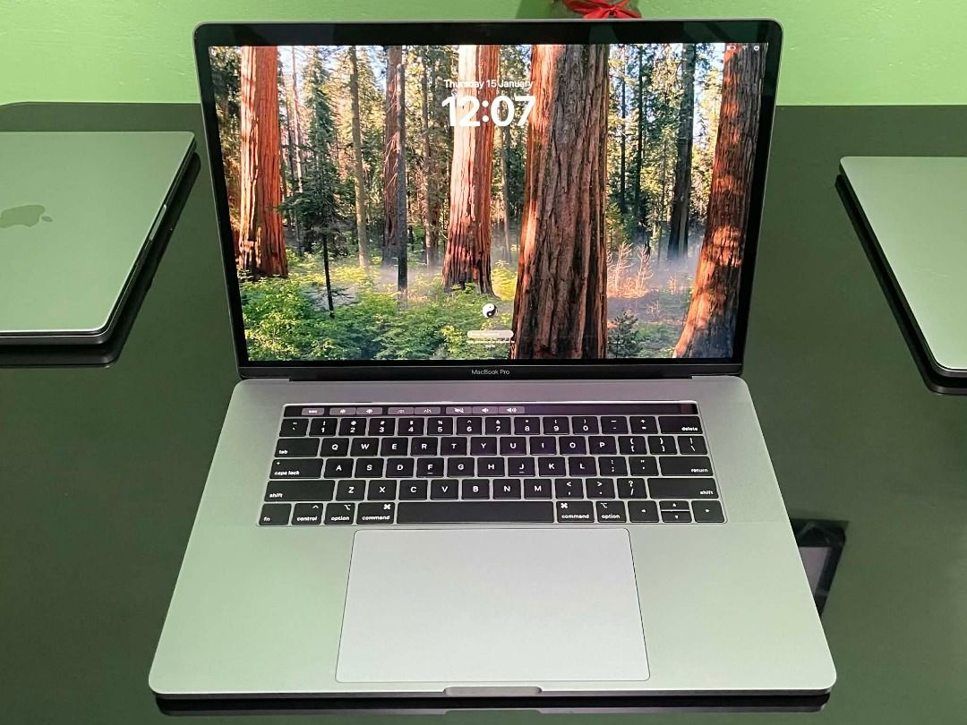 Apple MacBook Pro i7 ( 2019 ) 13 inch touch bar (Category: Laptops & Notebooks) located in Pasay City. Submitted by janrickz (Listing ID 1417759461, Image 3). Description: - Apple MacBook Pro i7 13-inch Touch bar - Space Grey - Features a large display - Includes a full-sized keyboard - Screen displays a forest image - Perfect for work and play.