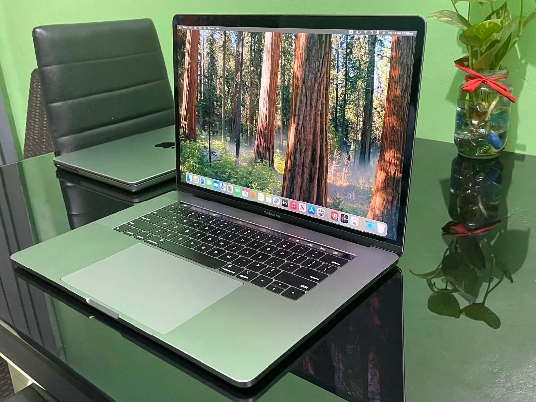 Apple MacBook Pro i7 ( 2019 ) 13 inch touch bar (Category: Laptops & Notebooks) located in Pasay City. Submitted by janrickz (Listing ID 1417759461, Image 1). Description: - Apple MacBook Pro i7 13-inch Touch bar - Space Grey - Features a large display - Includes a full-sized keyboard - Screen displays a forest image - Perfect for work and play.