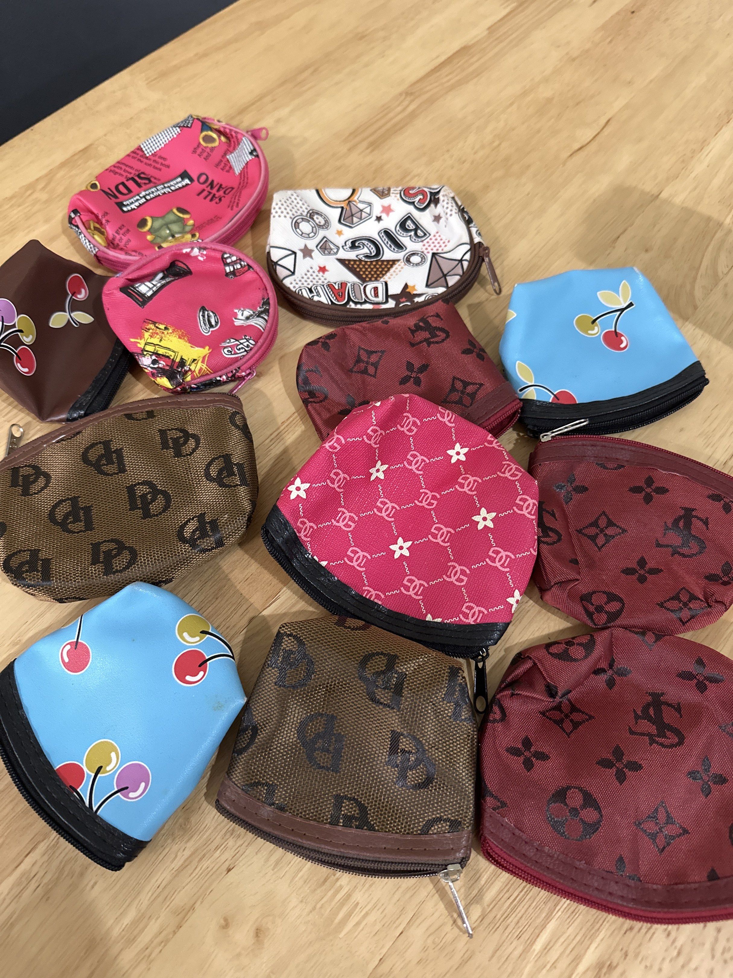 Assorted Pattern Coin Purses (Category: Purses & Pouches) located in Kuala Lumpur. Submitted by hongsy2017 (Listing ID 1417746356, Image 1). Description: - Coin purses with assorted designs. - Designs include cherry, floral, and monogram patterns. - Features a secure zipper closure. - Available in pink, brown, and blue colors. -Total 12 pieces - Ideal for storing coins, small items, or as a gift..