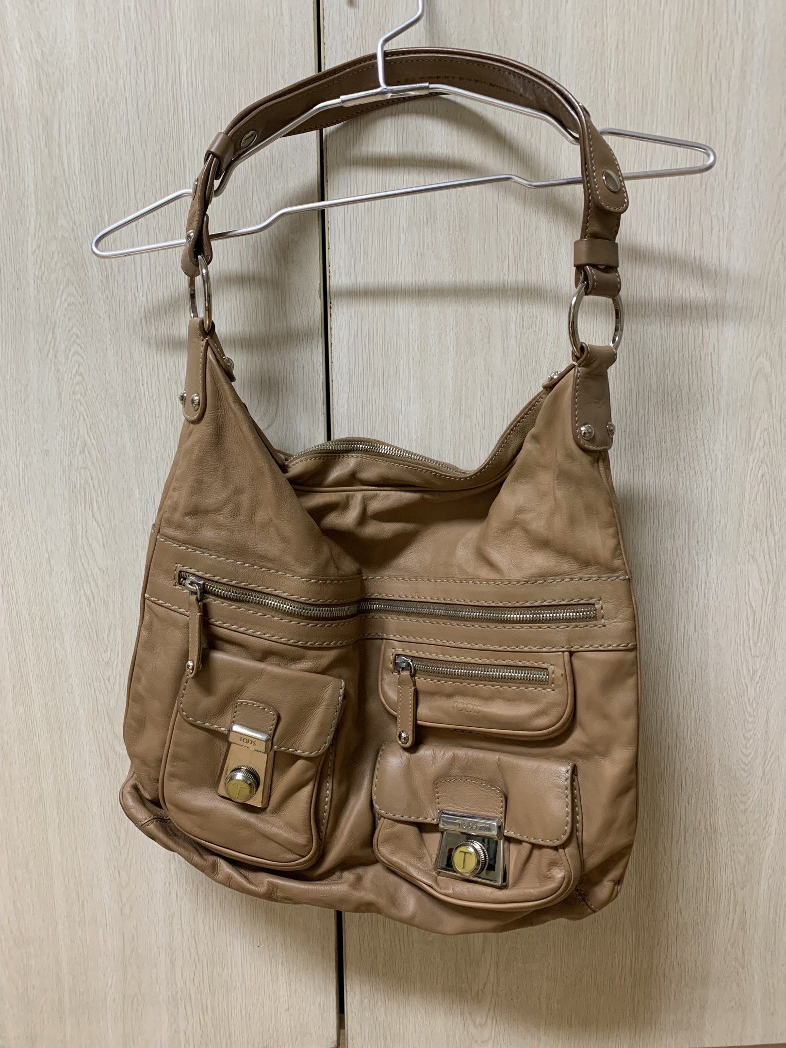 Authentic Tod's Leather Bag (Category: Luxury Bags & Wallets) located in San Juan City. Submitted by andyria (Listing ID 1417755921, Image 1). Description: - Tod's shoulder bag - Made of leather - Multiple exterior pockets - Secure zip closure - Versatile top handle and shoulder strap - Iconic Tod's metal clasp Flaw: last pic - faded patch at the back.